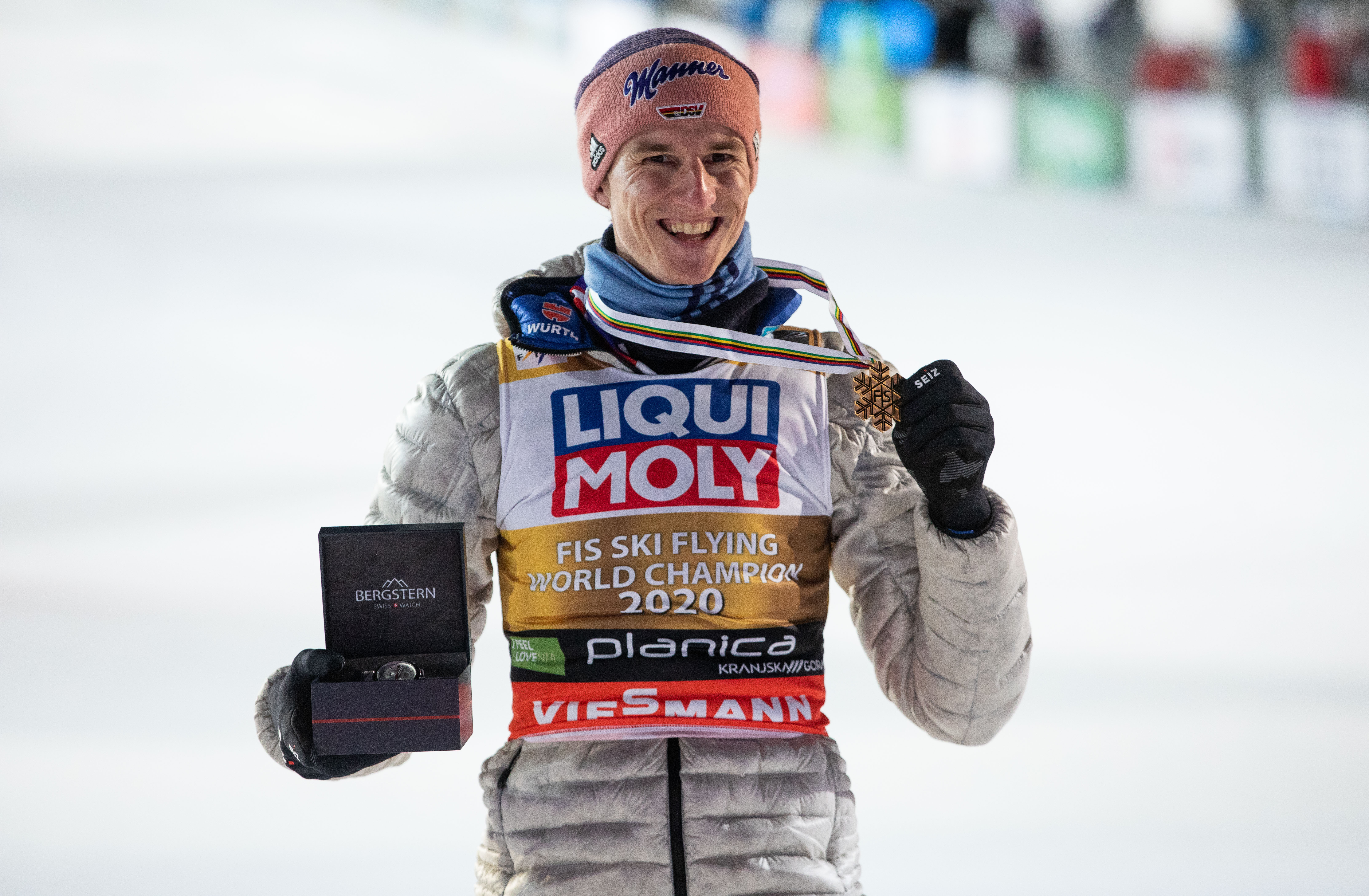 epa08879878 Karl Geiger of Germany poses with his gold medal on the podium after winning the HS240 competition of the FIS Ski Flying World Championships in Planica, Slovenia, 12 December 2020.  EPA-EFE/VID PONIKVAR