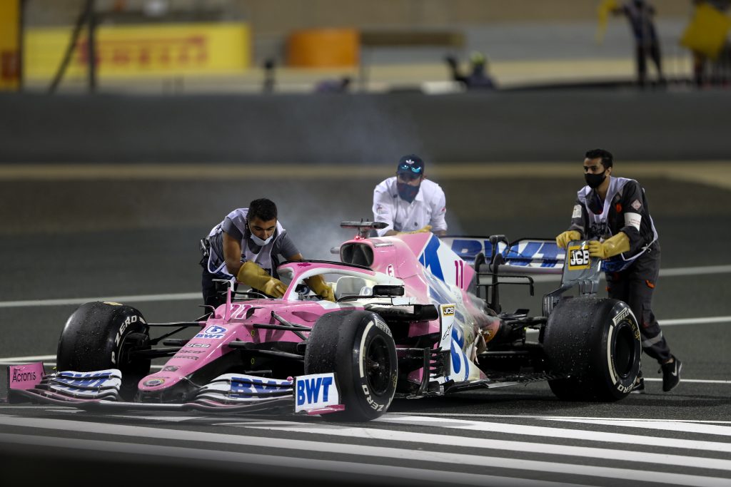 epa08851493 Ground marshals push the car of Mexican Formula One driver Sergio Perez of BWT Racing Point during the Formula One Grand of Bahrain on the Bahrain International Circuit in Sakhir, Bahrain 29 November 2020. 20.  EPA-EFE/Kamran Jebreili / Pool