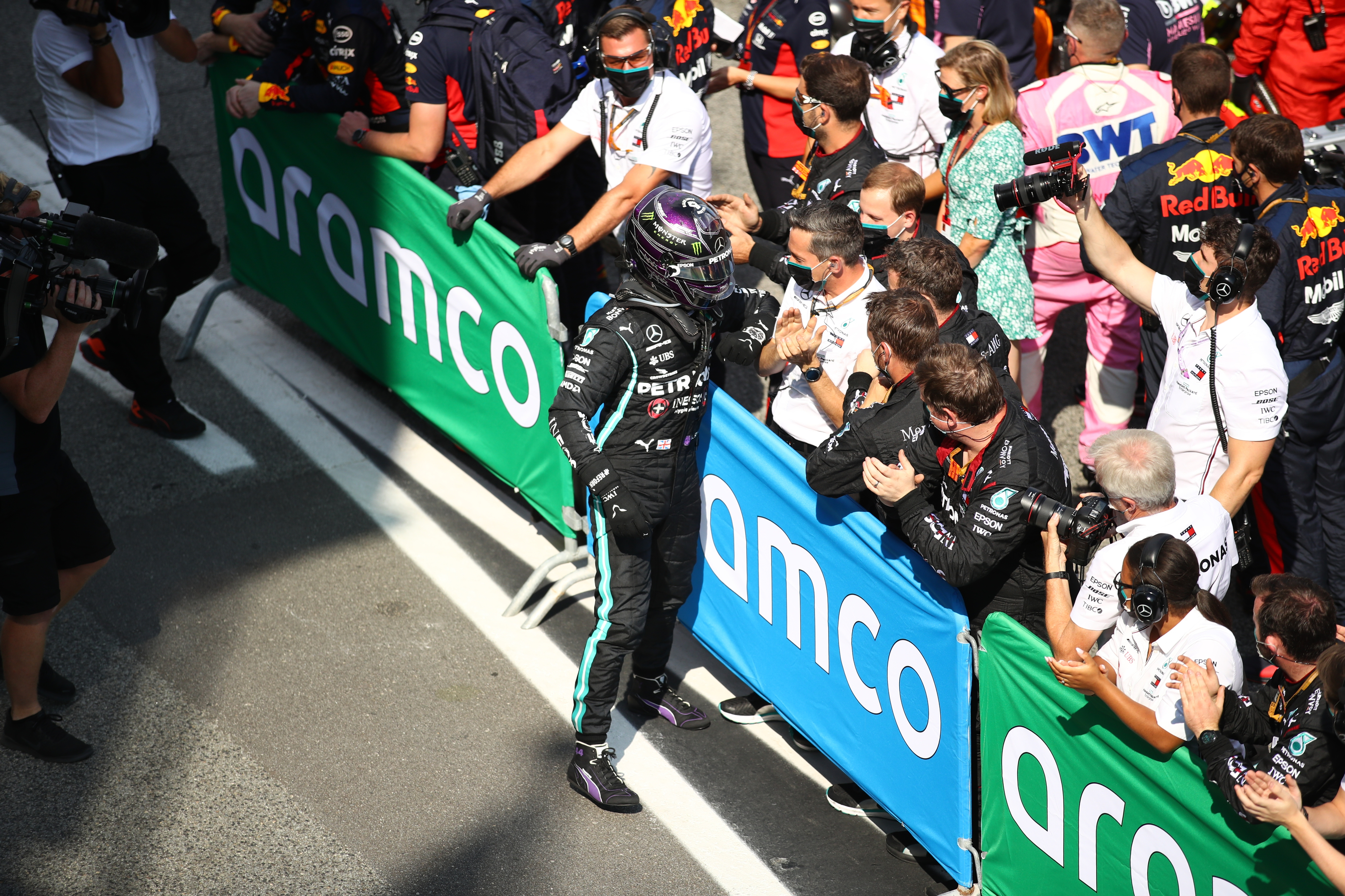 epa08607519 British Formula One driver Lewis Hamilton of Mercedes-AMG Petronas celebrates with team members after the Formula One Grand Prix of Spain at the Circuit de Barcelona-Catalunya in Montmelo, Spain, 16 August 2020.  EPA-EFE/Bryn Lennon/ Pool