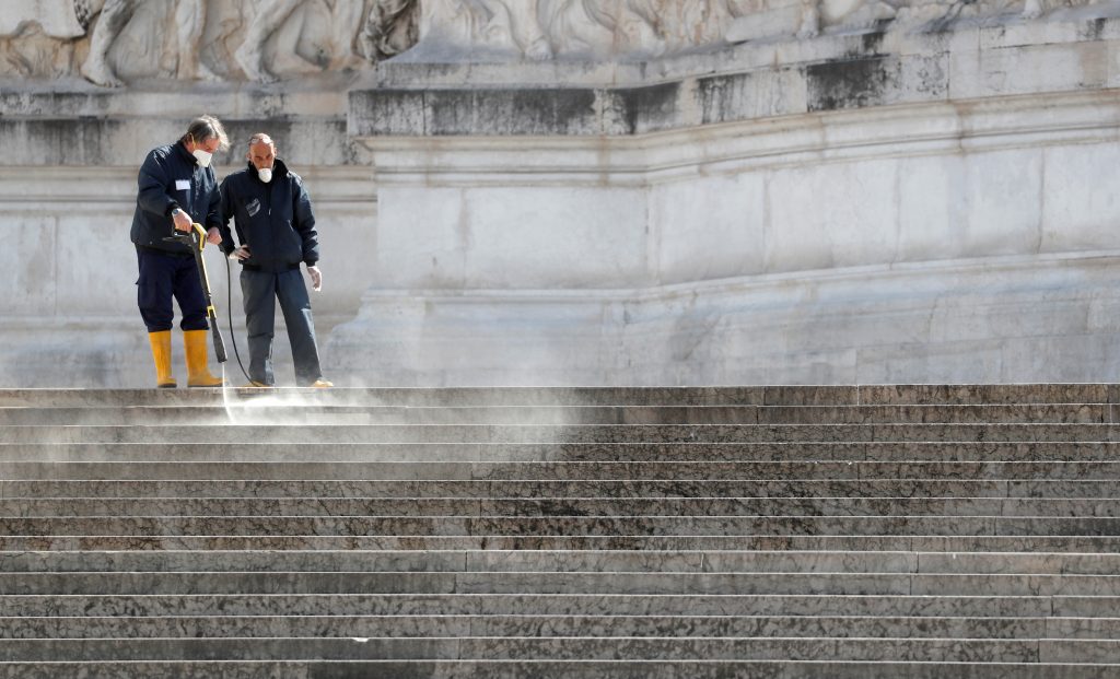 Workers clean stairs at Piazza Venezia as the spread of coronavirus disease (COVID-19) continues in Rome, Italy, March 25, 2020. REUTERS/Yara Nardi - RC21RF9AAIBF
