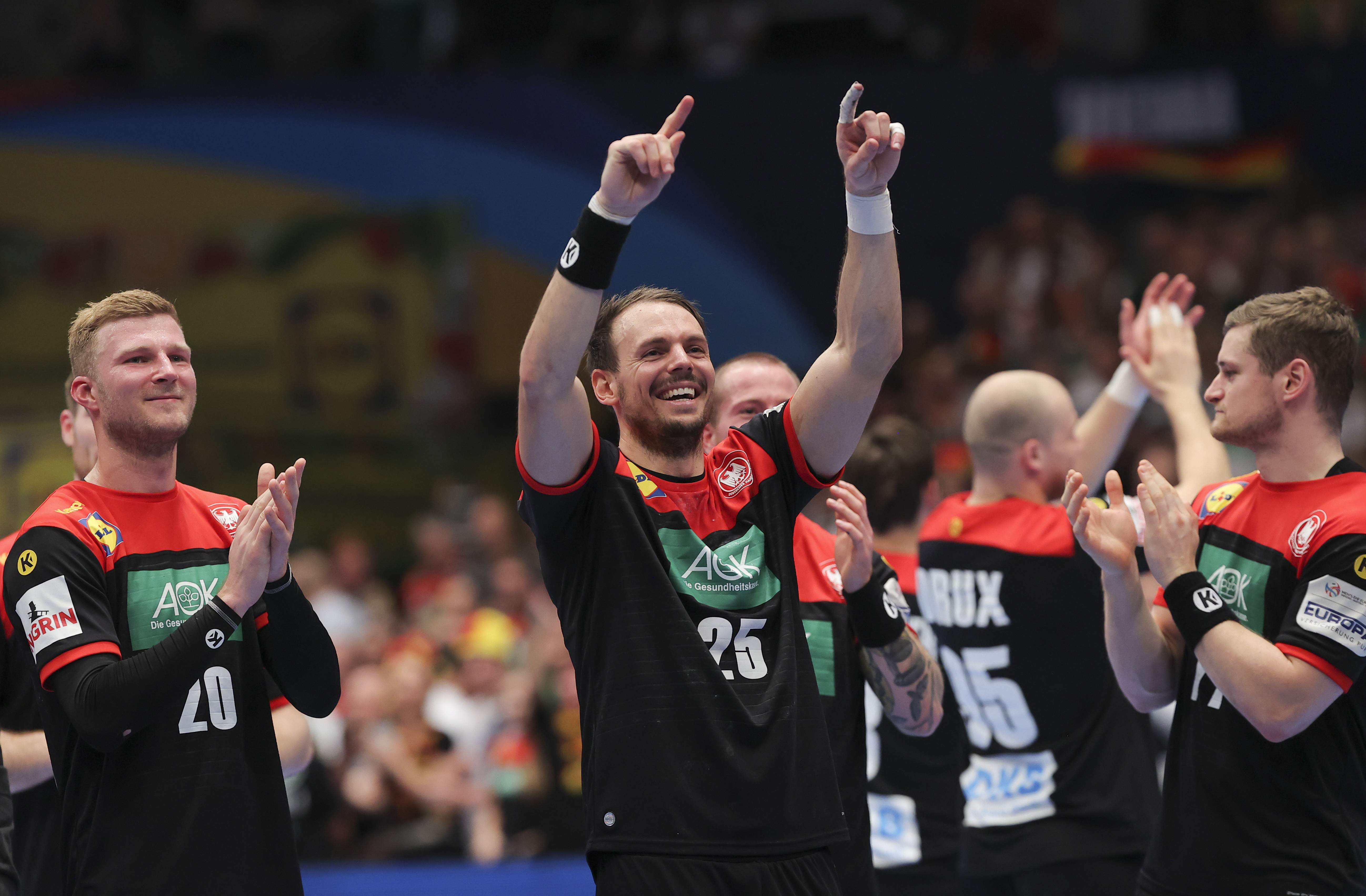 epa08145513 German players Philipp Weber (L) and 
Kai Hafner (C) celebrate after the EHF Handball Men European Championship match, main round between Austria and Germany in Vienna, Austria, 20 January 2020.  EPA-EFE/VALDRIN XHEMAJ