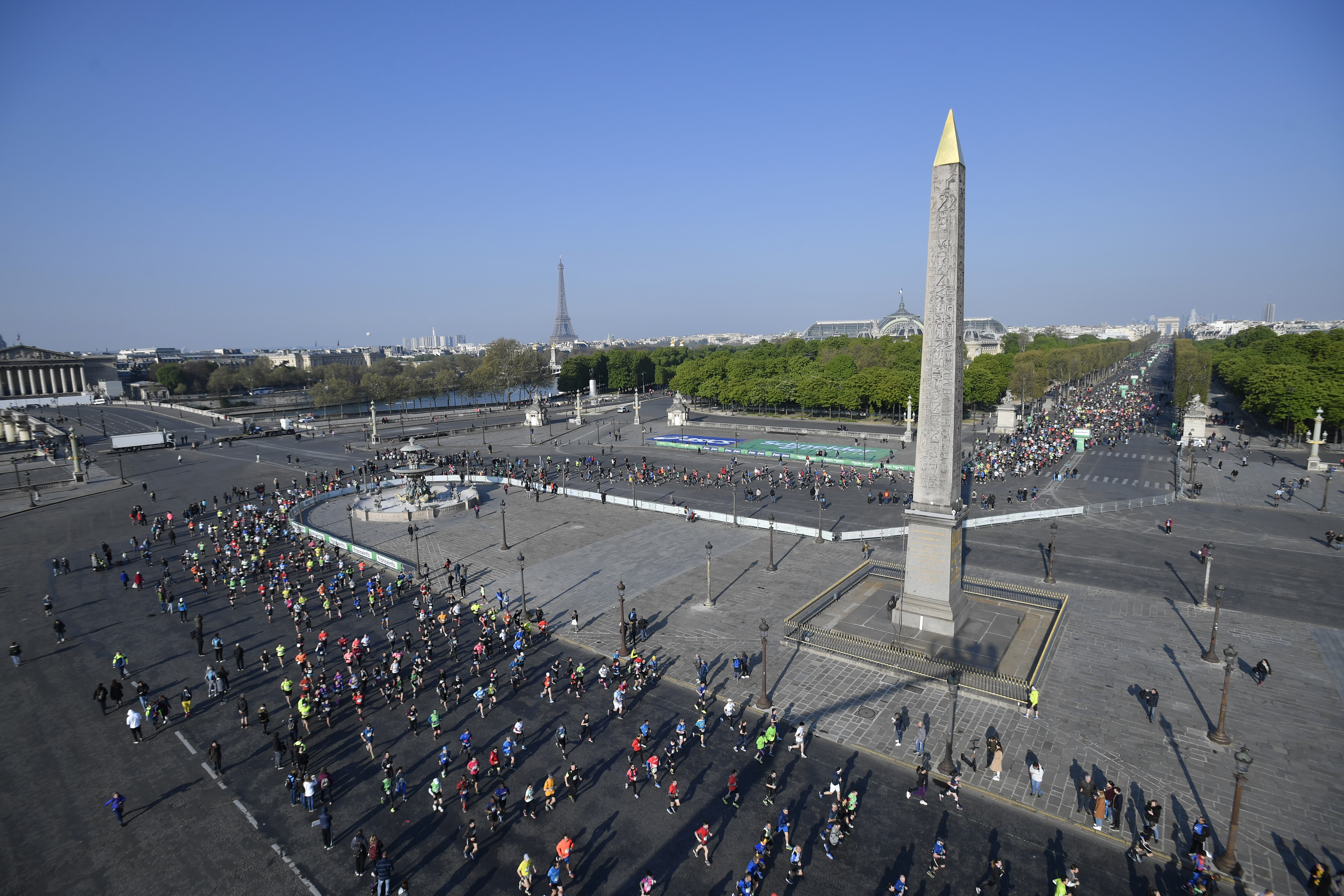 epa07505729 Runners pass by the Obelisk on Place de la Concorde as they compete in the 43th Paris Marathon in Paris, France, 14 April 2019.  EPA-EFE/JULIEN DE ROSA