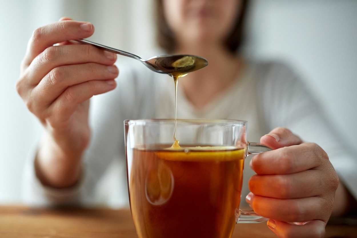 healthy food, eating and ethnoscience concept - close up of woman adding honey to tea cup with lemon,Image: 306126869, License: Royalty-free, Restrictions: , Model Release: yes, Credit line: Lev Dolgachov / Alamy / Alamy / Profimedia
