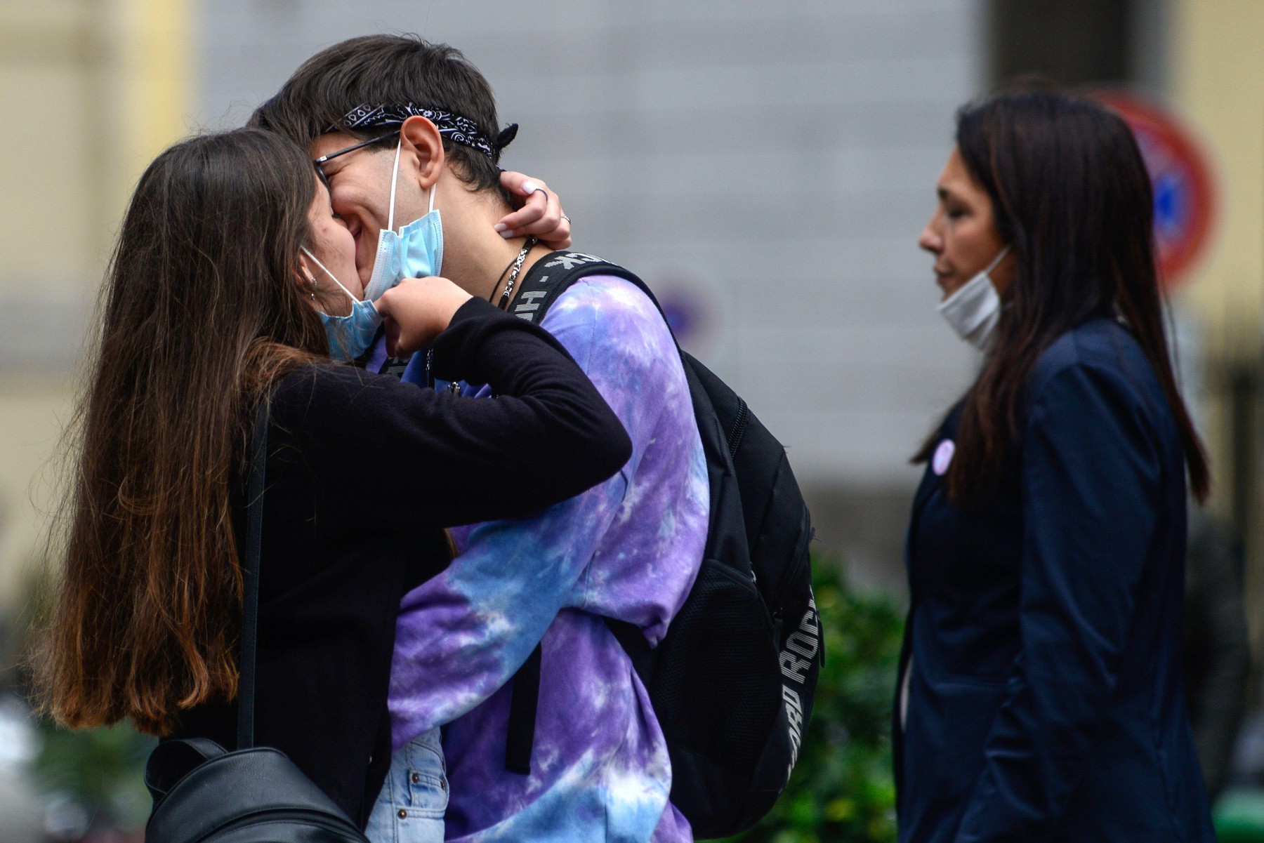 Naples, Italy. 20th Oct, 2020. Love in the time of the Coronavirus, two lovers with masks meets and kisses, lowering the masks and embracing each other. Despite the rules of social distancing, issued by the government to combat coronavirus contagion (COVI