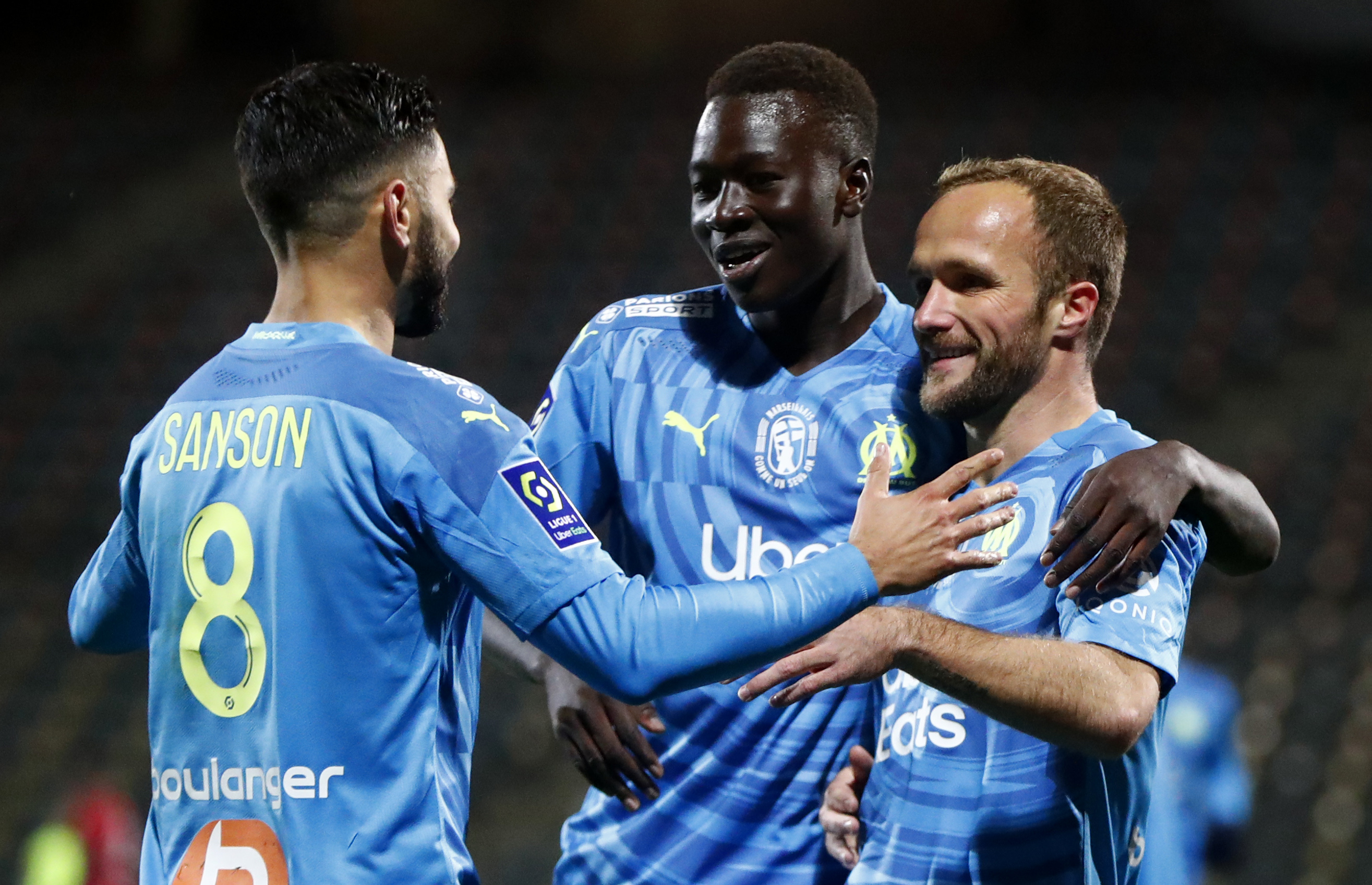 epa08863058 Valere Germain (R) of Olympique Marseille celebrates a goal with his team mates during the French Ligue 1 soccer match between Nimes Olympique and Olympique Marseille, in Nimes, France, 04 December 2020.  EPA-EFE/Guillaume Horcajuelo