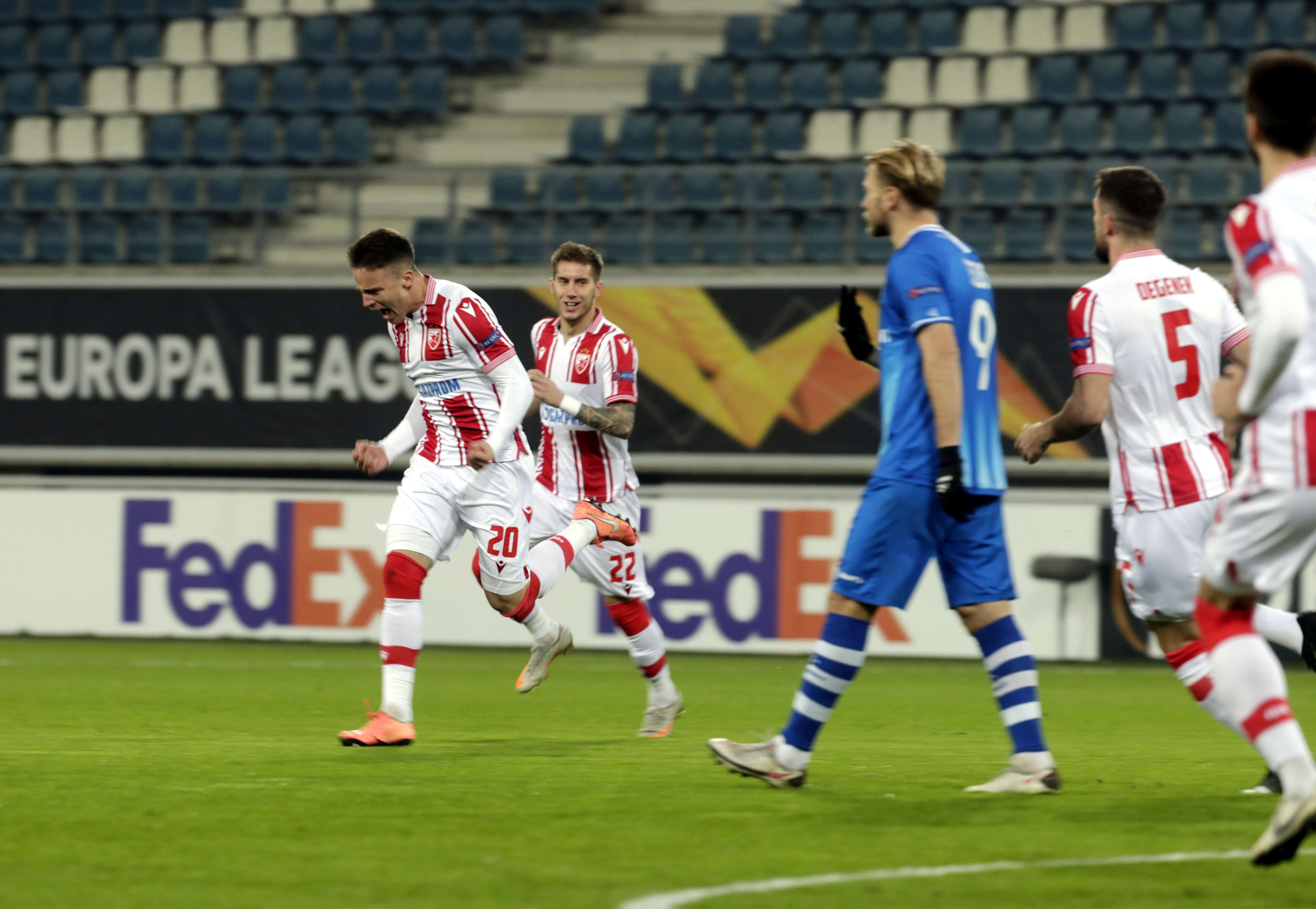 epa08844246 Red Star's Njegos Petrovic (L) celebrates with teammates after scoring the 0-1 lead during the UEFA Europa League Group L soccer match between KAA Gent and Red Star Belgrade in Gent, Belgium, 26 November 2020.  EPA-EFE/STEPHANIE LECOCQ