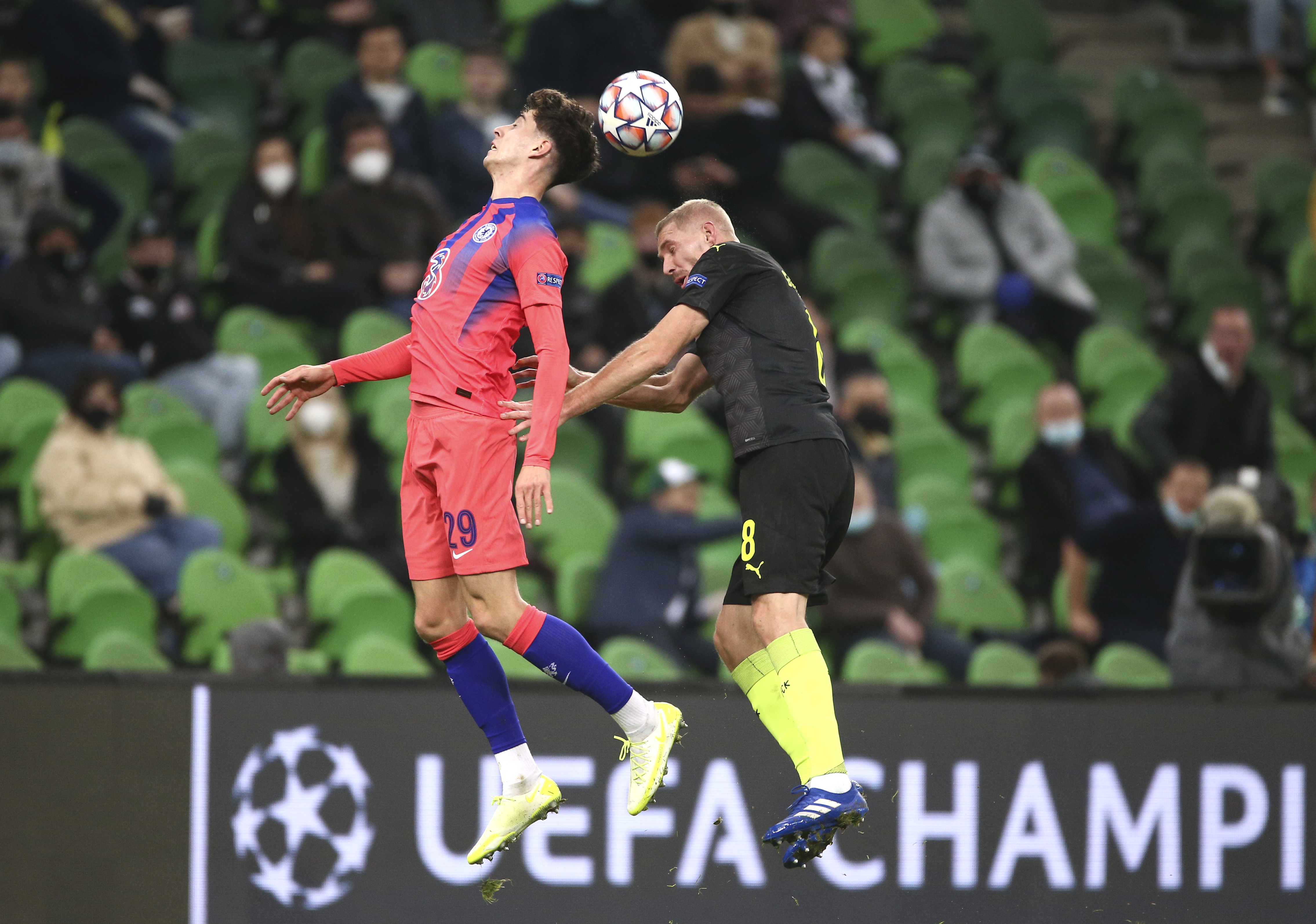 Chelsea's Kai Havertz, left, and Krasnodar's Yury Gazinsky challenge for the ball during the Champions League Group E soccer match between Krasnodar and Chelsea in Krasnodar, Russia, Wednesday, Oct. 28, 2020. (AP Photo)