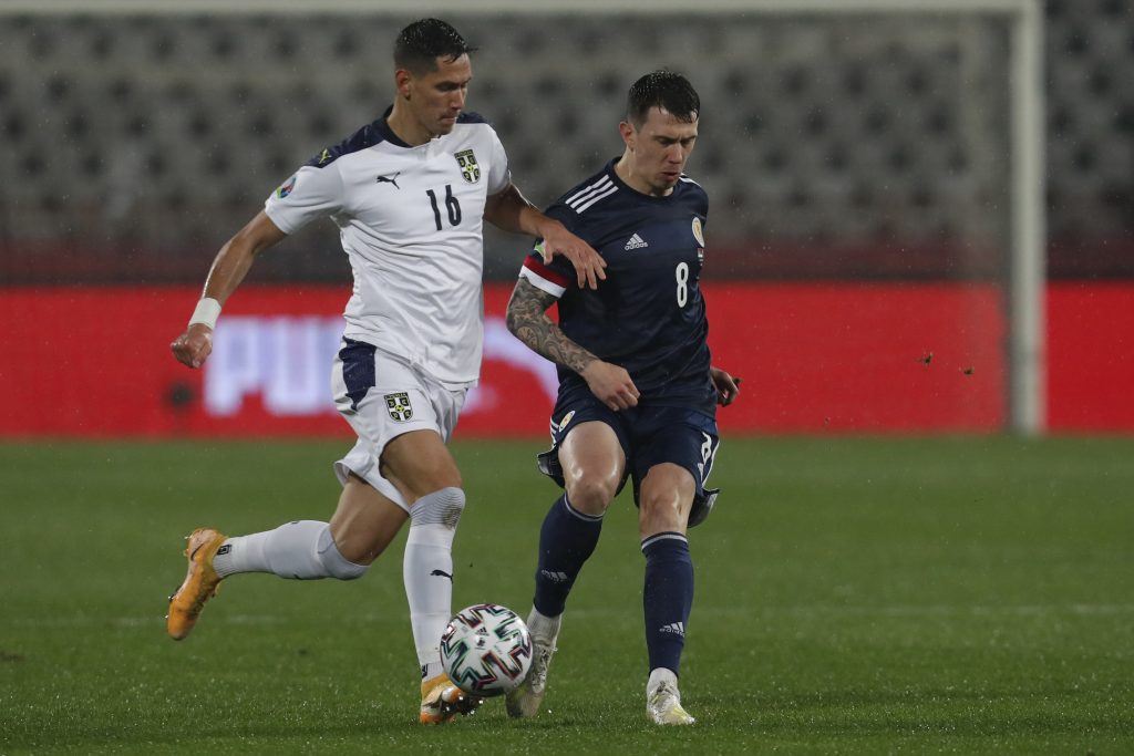 Serbia's Sasa Lukic, left, fights for the ball with Scotland's Ryan Jack during the Euro 2020 playoff final soccer match between Serbia and Scotland, at the Rajko Mitic stadium in Belgrade, Serbia, Thursday, Nov. 12, 2020. (AP Photo/Darko Vojinovic)