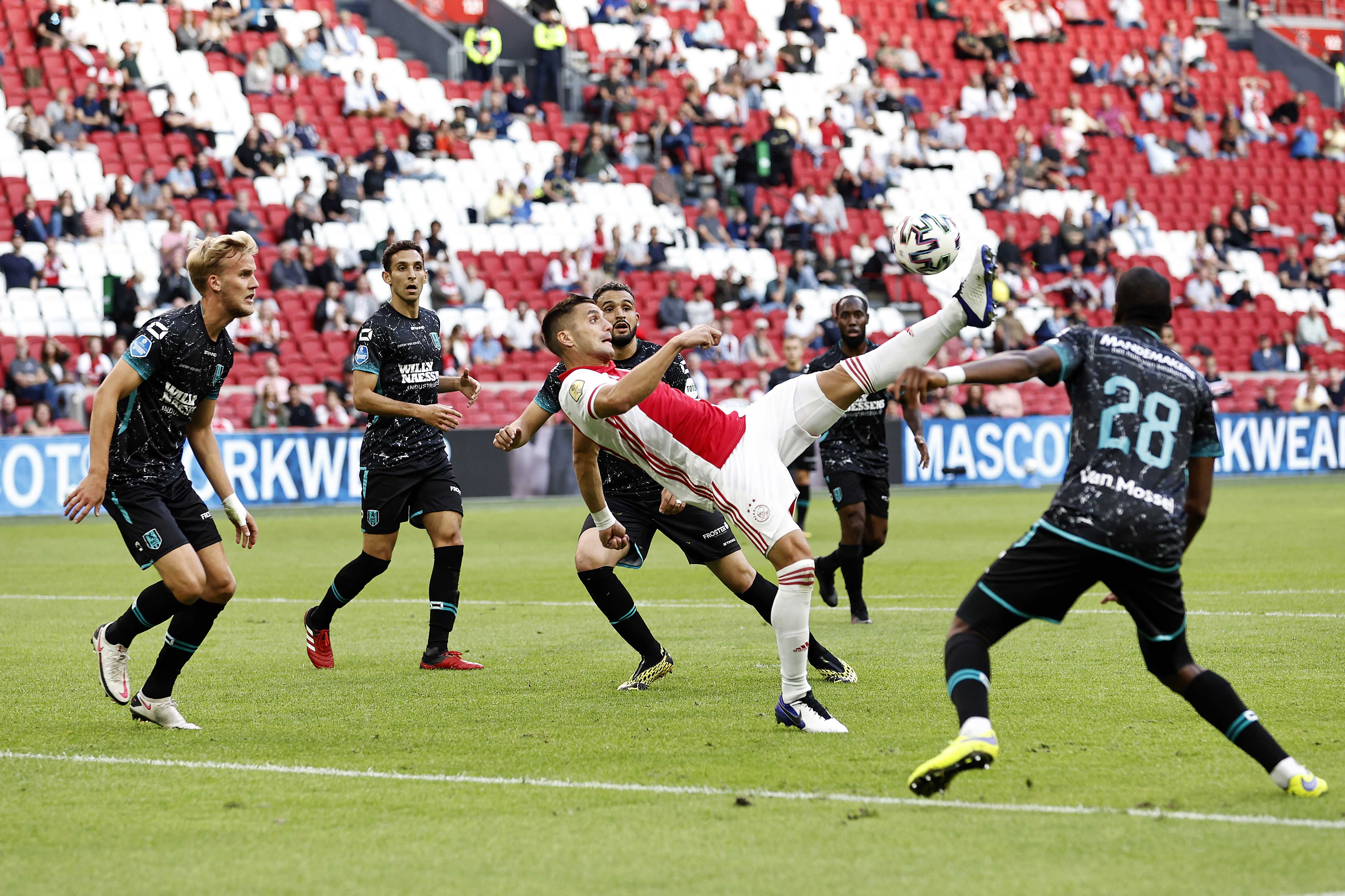 epa08684132 Dusan Tadic (C) of Ajax scores the 1-0 goal during the Dutch Eredivisie soccer match between Ajax Amsterdam and RKC Waalwijk at the Johan Cruijff Arena in Amsterdam, The Netherlands, 20 September 2020.  EPA-EFE/MAURICE VAN STEEN