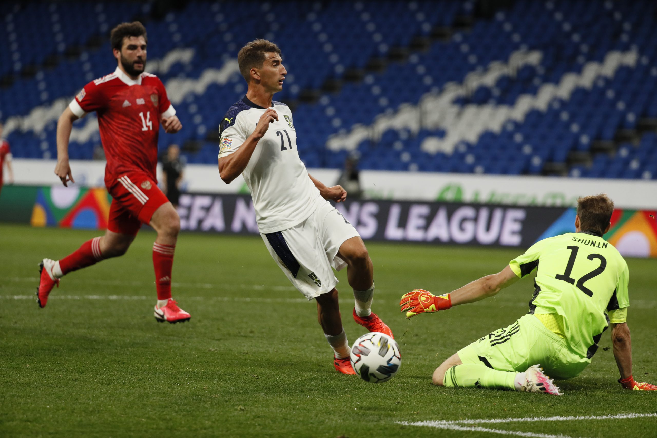 epa08644923 Anton Shunin of Russia in action against Filip Djuricic (C) of Serbia during the UEFA Nations League Group stage match between Russian and Serbia in Moscow, Russia, 03 September 2020.  EPA-EFE/YURI KOCHETKOV