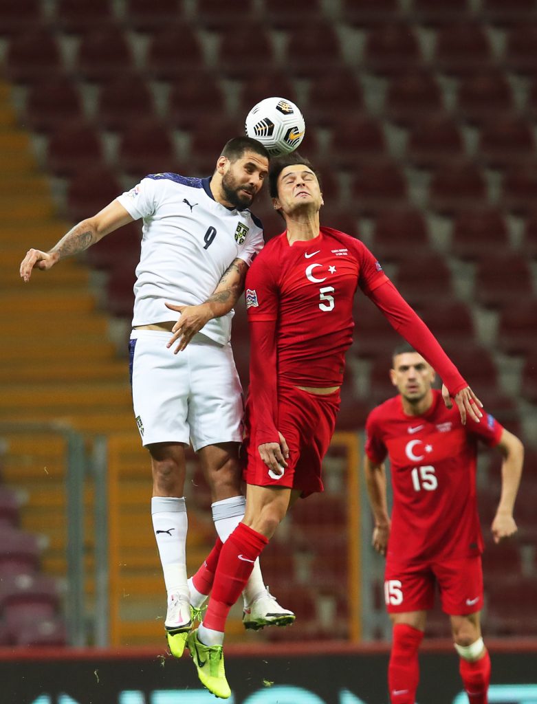 epa08745151 Okay Yokuslu (R) of Turkey in action against Aleksandar Mitrovic (L) of Serbia during the UEFA Nations League soccer match between Turkey and Serbia in Istanbul, Turkey, 14 October 2020.  EPA-EFE/TOLGA BOZOGLU