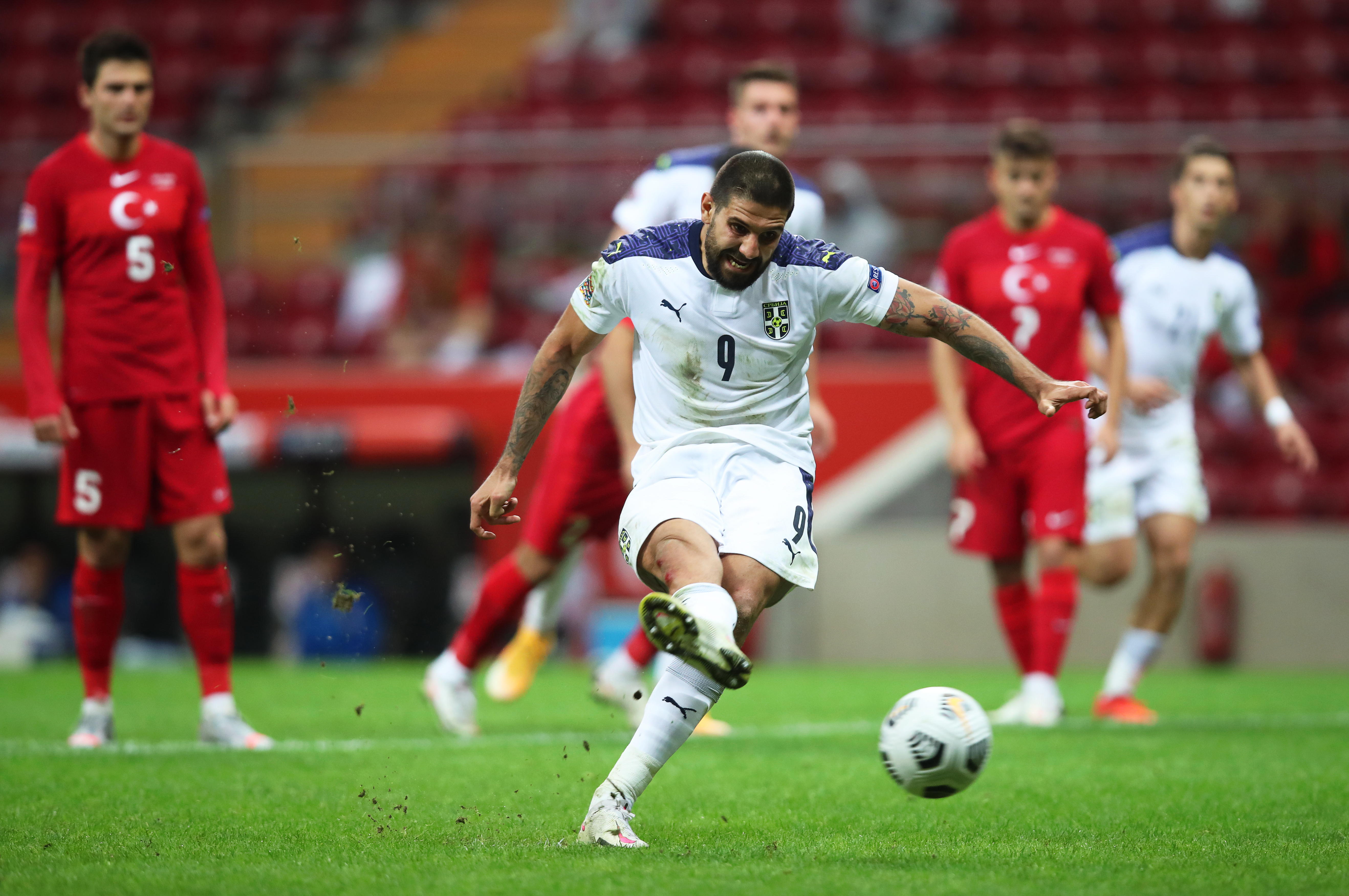 epa08745547 Aleksandar Mitrovic (C) of Serbia scores the 2-0 lead from the penalty spot during the UEFA Nations League soccer match between Turkey and Serbia in Istanbul, Turkey, 14 October 2020.  EPA-EFE/TOLGA BOZOGLU