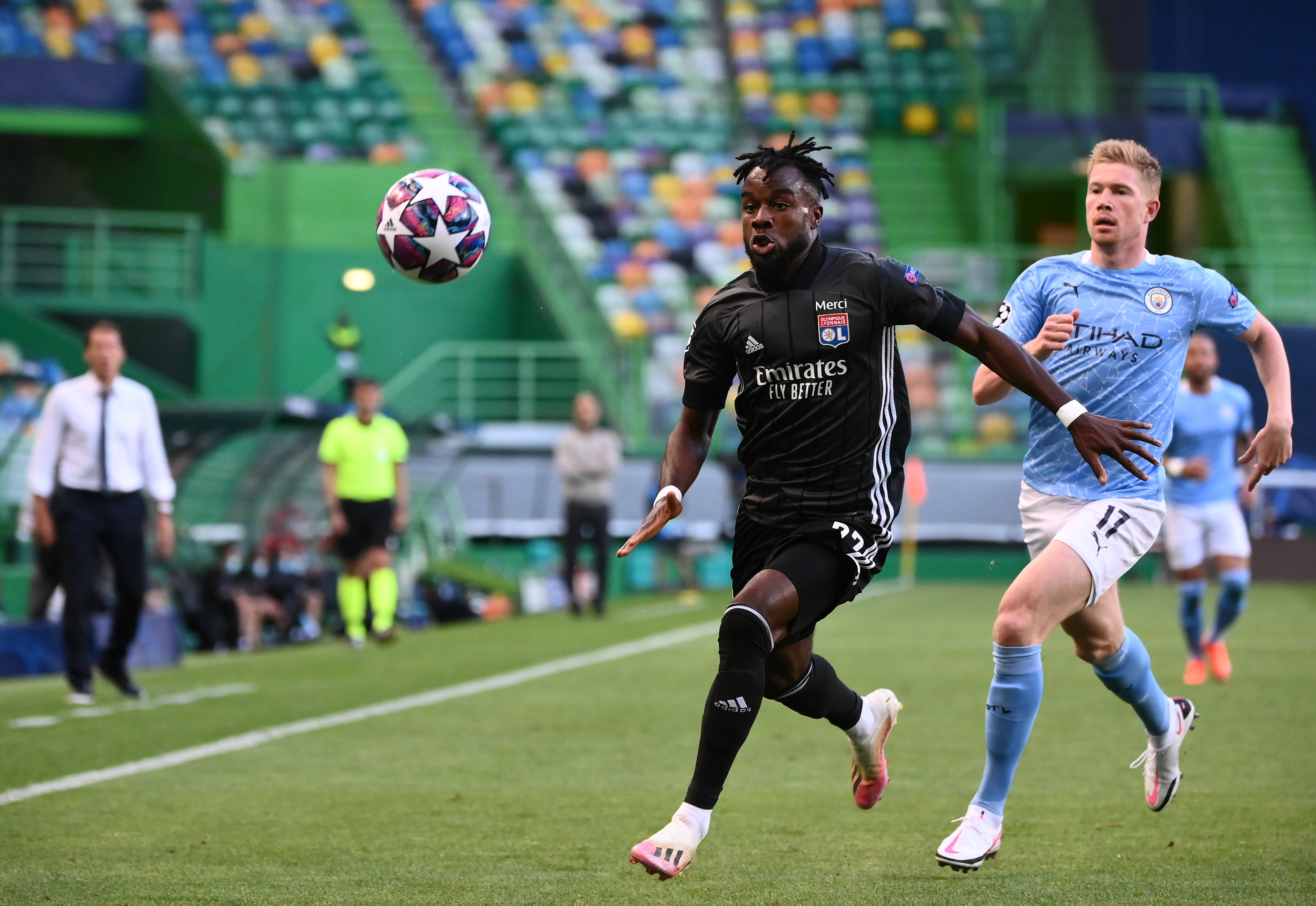 epa08606093 Kevin De Bruyne (R) of Manchester City in action against Maxwel Cornet of Lyon during the UEFA Champions League quarter final match between Manchester City and Olympique Lyon in Lisbon, Portugal, 15 August 2020.  EPA-EFE/Franck Fife / POOL