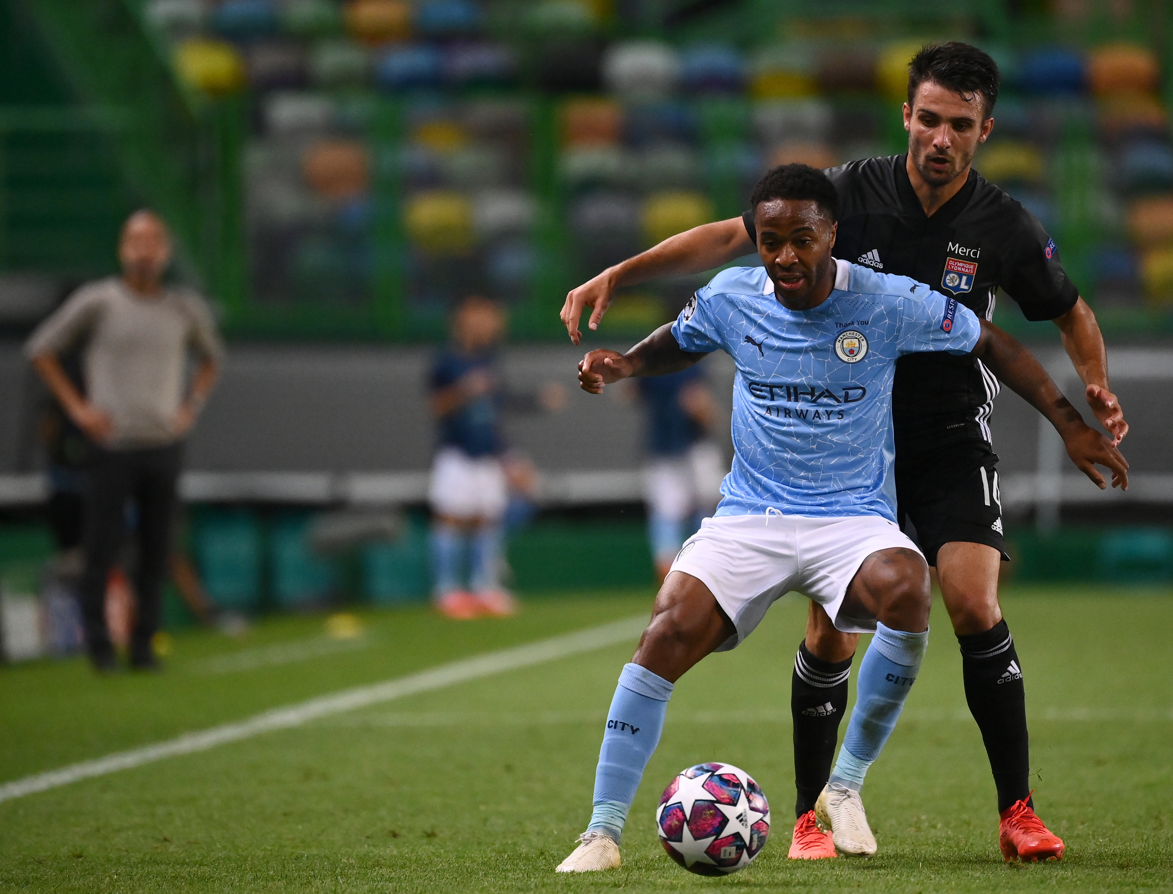 epa08606332 Raheem Sterling (L) of Manchester City in action against Leo Dubois of Lyon during the UEFA Champions League quarter final match between Manchester City and Olympique Lyon in Lisbon, Portugal, 15 August 2020.  EPA-EFE/Franck Fife / POOL