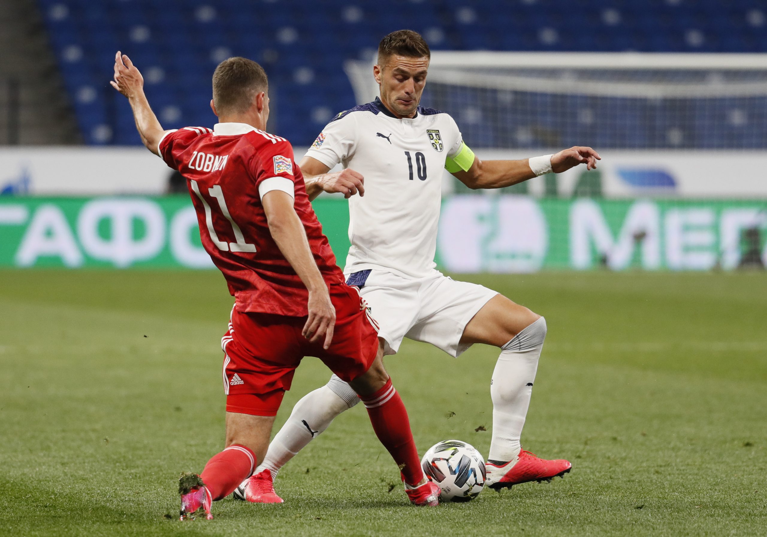 epa08644654 Roman Zobnin (L) of Russia in action against Dusan Tadic (R) of Serbia during the UEFA Nations League Group stage match between Russian and Serbia in Moscow, Russia, 03 September 2020.  EPA-EFE/YURI KOCHETKOV
