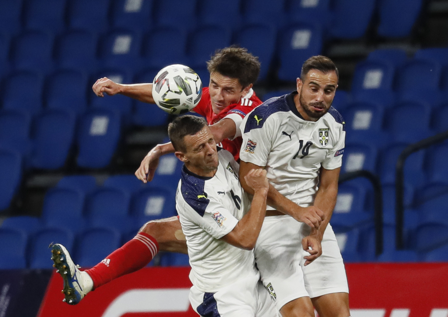 epa08644757 Yuri Zhirkov (C) of Russia in action against Nemanja Maksimovic (L) and Nikola Maksimovic (R)of Serbia during the UEFA Nations League Group stage match between Russian and Serbia in Moscow, Russia, 03 September 2020.  EPA-EFE/YURI KOCHETKOV