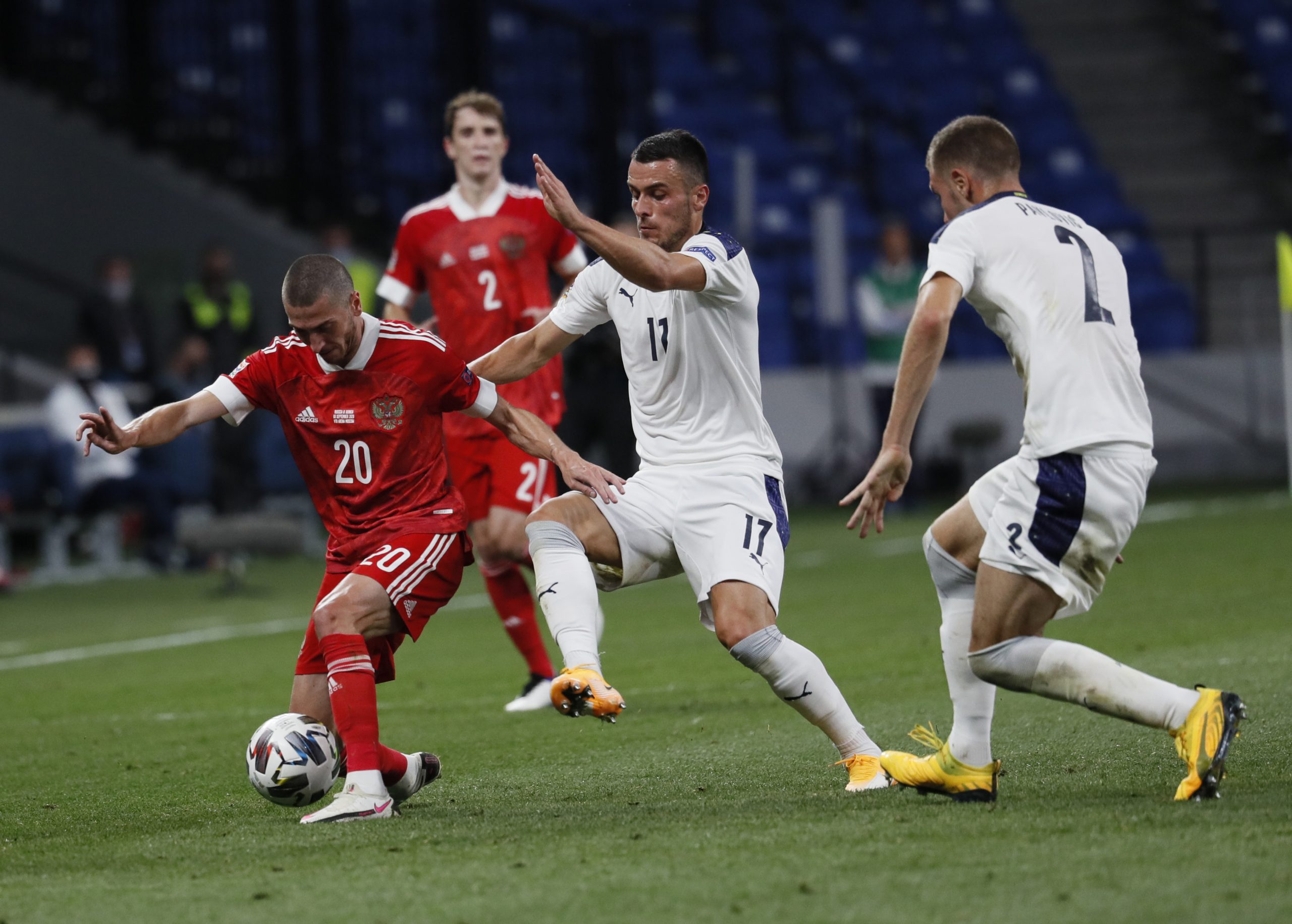 epa08644759 Aleksei Ionov (L) of Russia in action against Filip Kostic (C) of Serbia during the UEFA Nations League Group stage match between Russian and Serbia in Moscow, Russia, 03 September 2020.  EPA-EFE/YURI KOCHETKOV