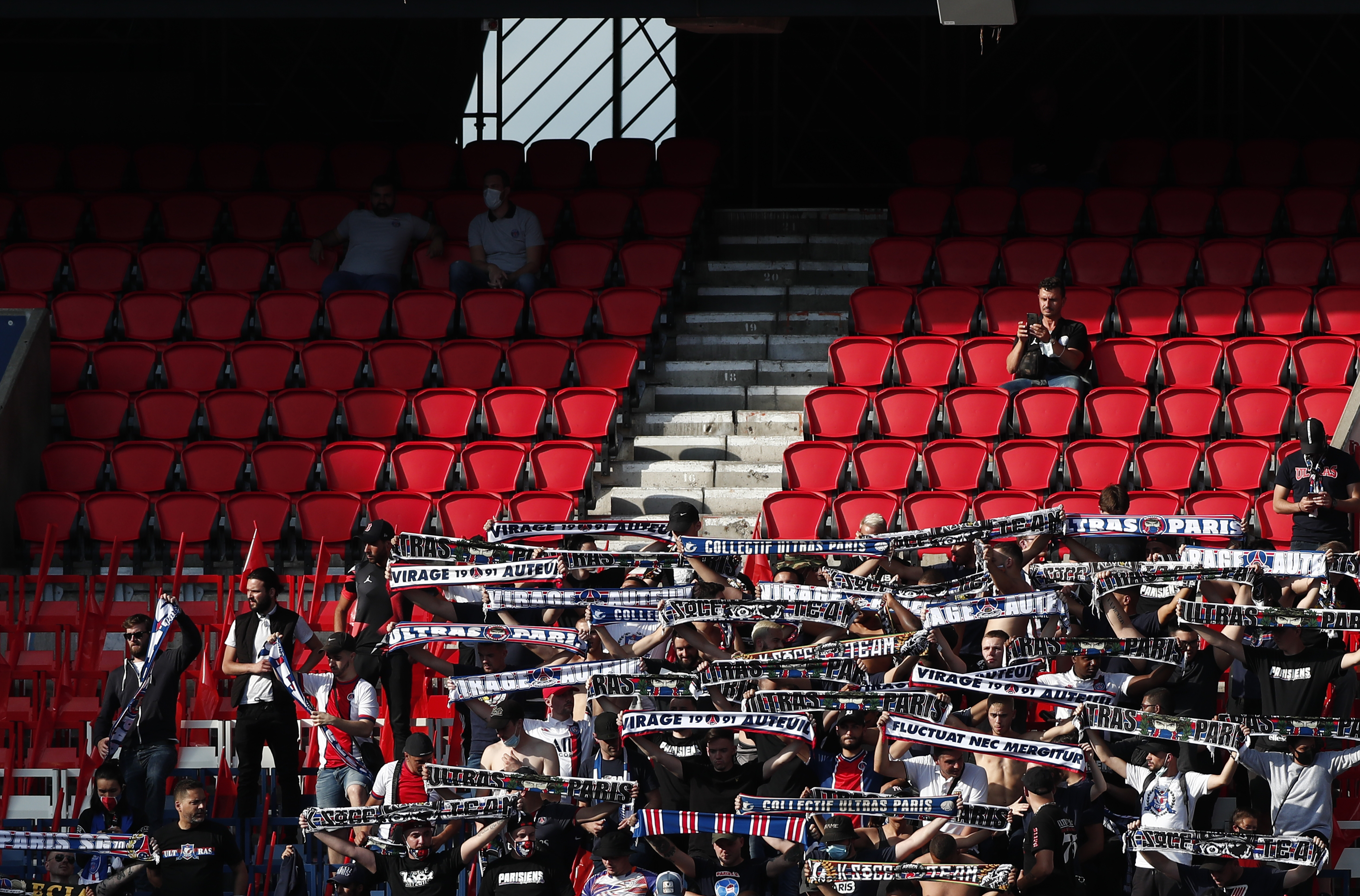 epa08552654 PSG supporters occupy a small portion of the otherwise empty stands  during the friendly soccer match between Paris Saint Germain and Belgian team Waasland Beveren, in Paris, 17 July 2020.  EPA-EFE/IAN LANGSDON