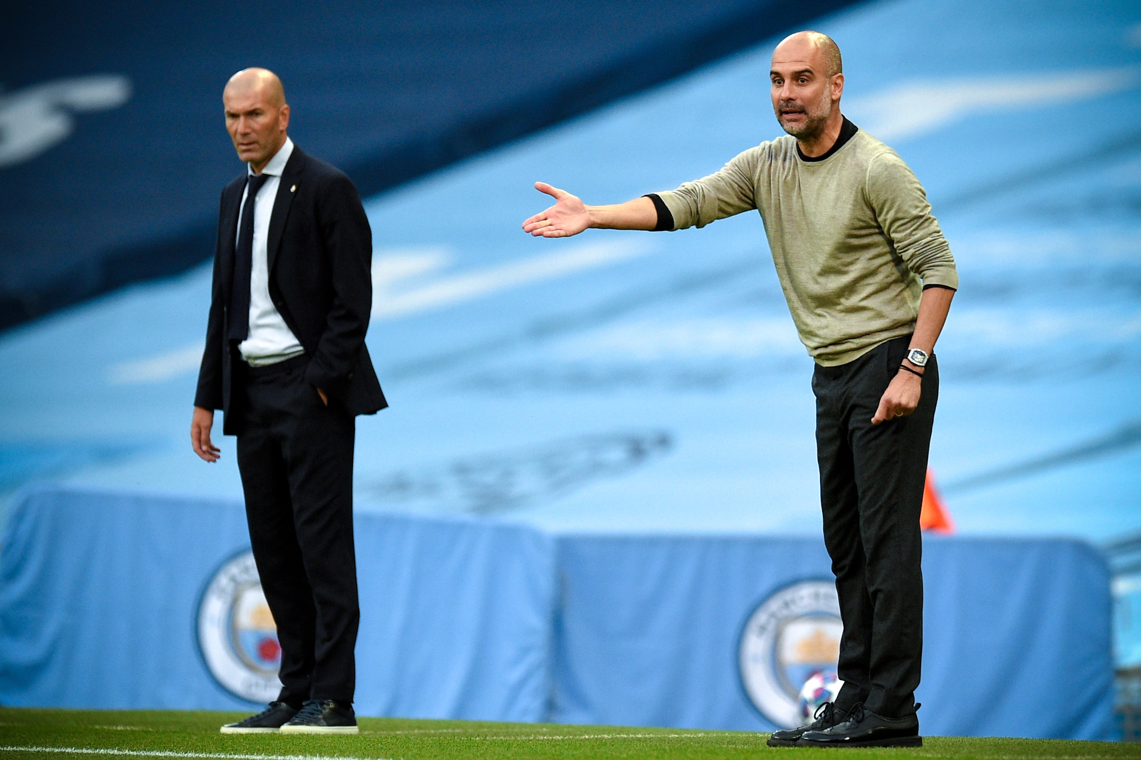 epa08590473 Manchester City's head coach Pep Guardiola (R) gestures during the UEFA Champions League Round of 16 second leg soccer match between Manchester City and Real Madrid in Manchester, Britain, 07 August 2020.  EPA-EFE/Oli Scarff / POOL