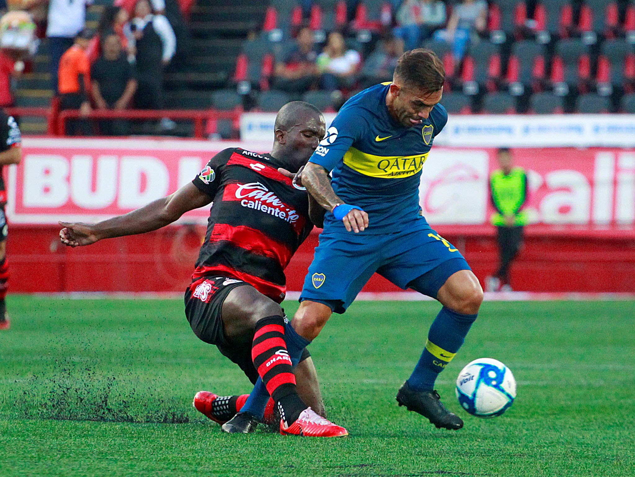 epa07709093 Xolos Tijuana's Kevin Balanta (L) vies for the ball against Carlos Tevez (R) of Boca Juniors during a friendly game held at the Caliente stadium in Tijuana, Mexico, 10 July 2019.  EPA-EFE/ALEJANDRO ZEPEDA