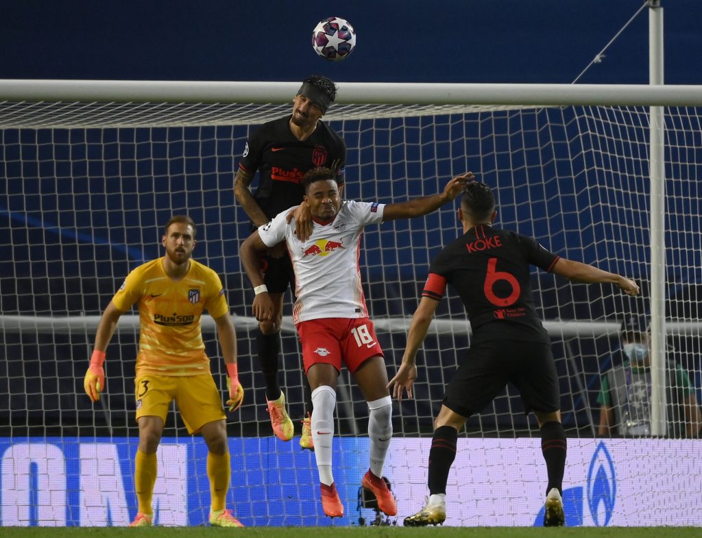 epa08601848 Stefan Savic (up) of Atletico goes for a header during the UEFA Champions League quarter final match between RB Leipzig and Atletico Madrid in Lisbon, Portugal, 13 August 2020.  EPA-EFE/Lluis Gene / POOL