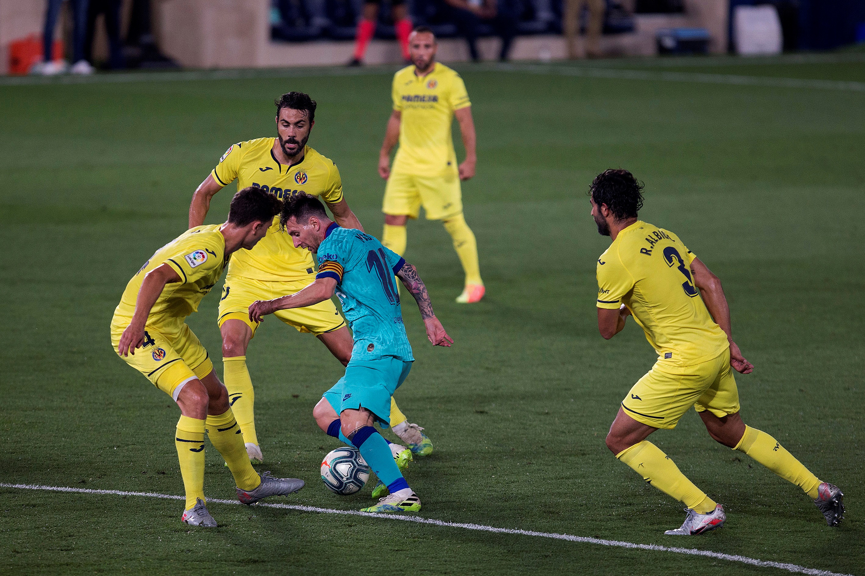 epa08529810 FC Barcelona´s Leo Messi (3L) in action against Villarreal's players during the Spanish La Liga soccer match between Villarreal CF and FC Barcelona at La Ceramica stadium in Villarreal, eastern Spain, 05 July 2020.  EPA-EFE/DOMENECH CASTELLO