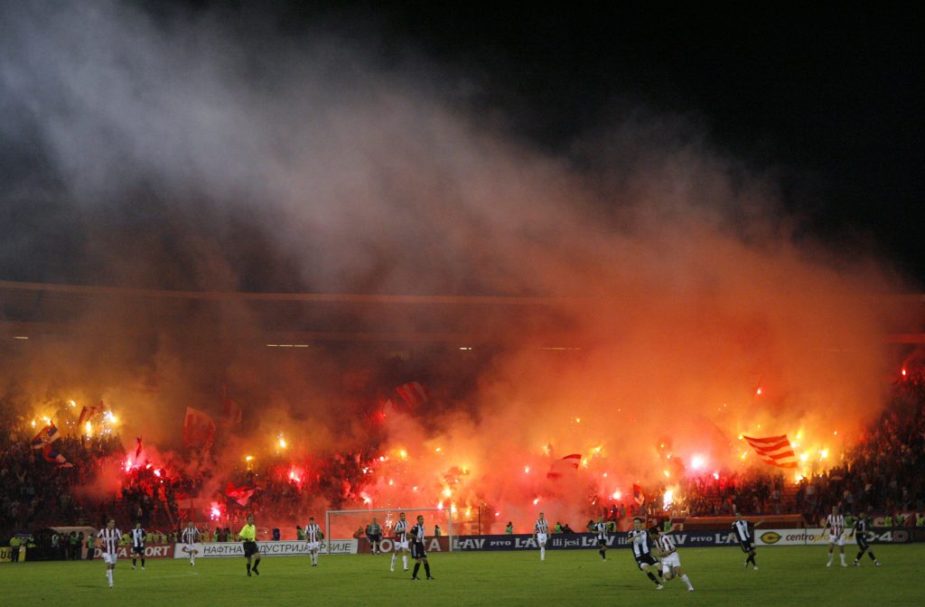 Red Star soccer fans light torches during their match with Partizan during their Serbian Cup semi-final soccer match in Belgrade April 18, 2007.  REUTERS/Ivan Milutinovic   (SERBIA) - GM1DVBMDPJAA