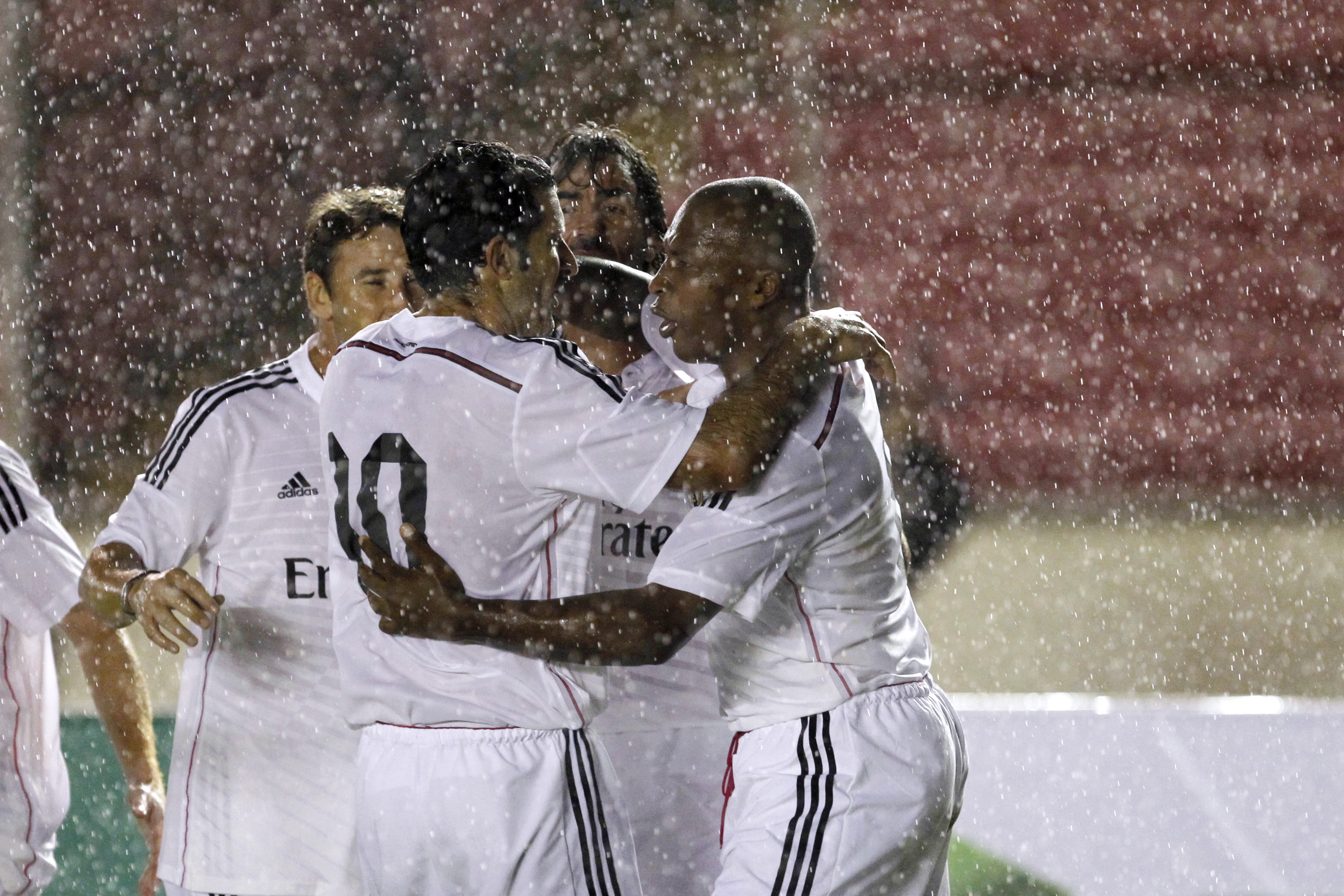 Former Real Madrid player Edwin Congo celebrates with his team mate Luis Figo after he scored a goal against Barcelona during an exhibition soccer match known as Legends Cup in Panama City
