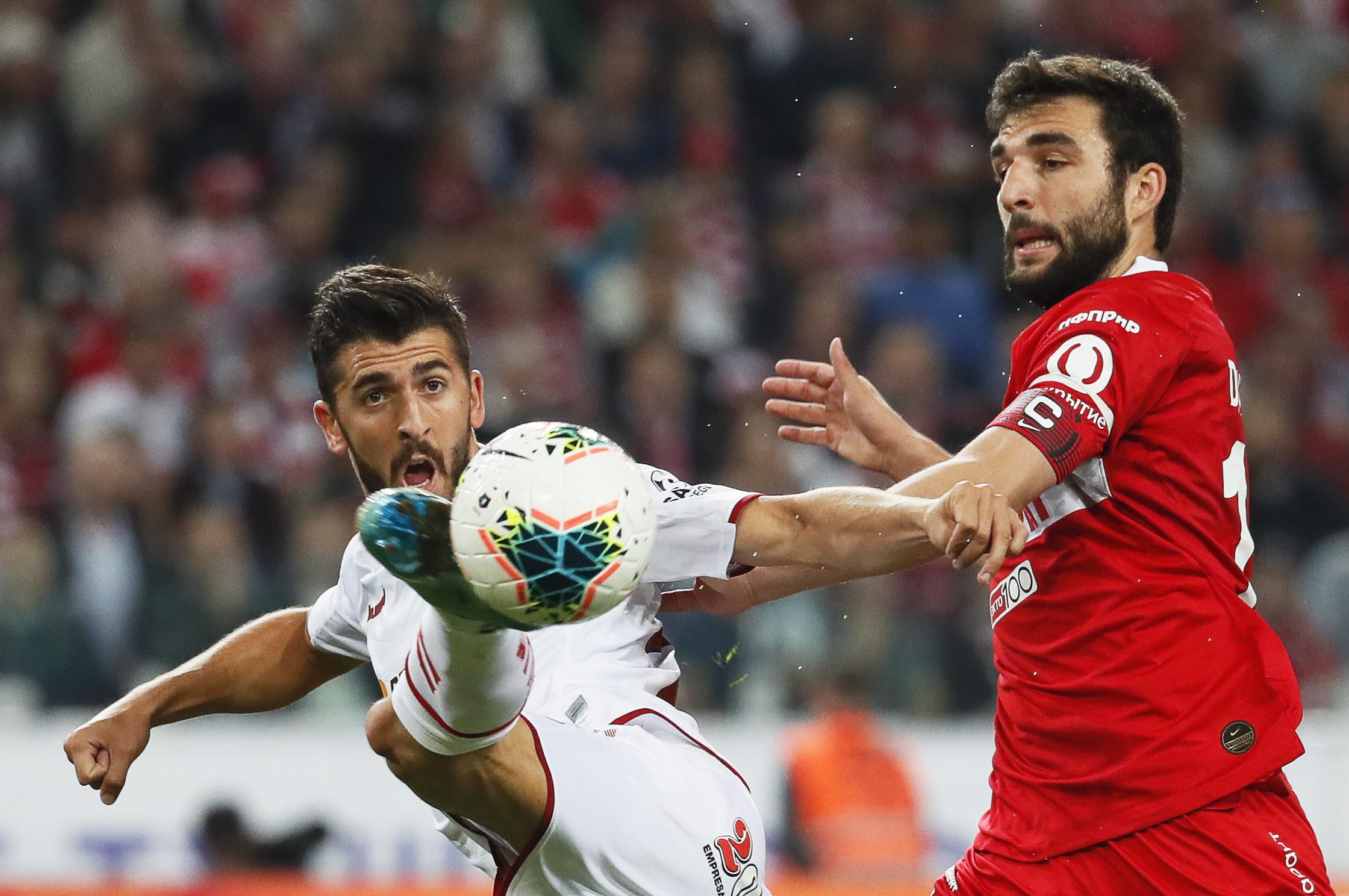 epa07802857 Georgi Dzhikiya (R) of Spartak in action against Paulinho (L) of Braga during the UEFA Europa League playoff, second leg soccer match between Spartak Moscow and Sporting Braga in Moscow, Russia, 29 August 2019.  EPA-EFE/YURI KOCHETKOV