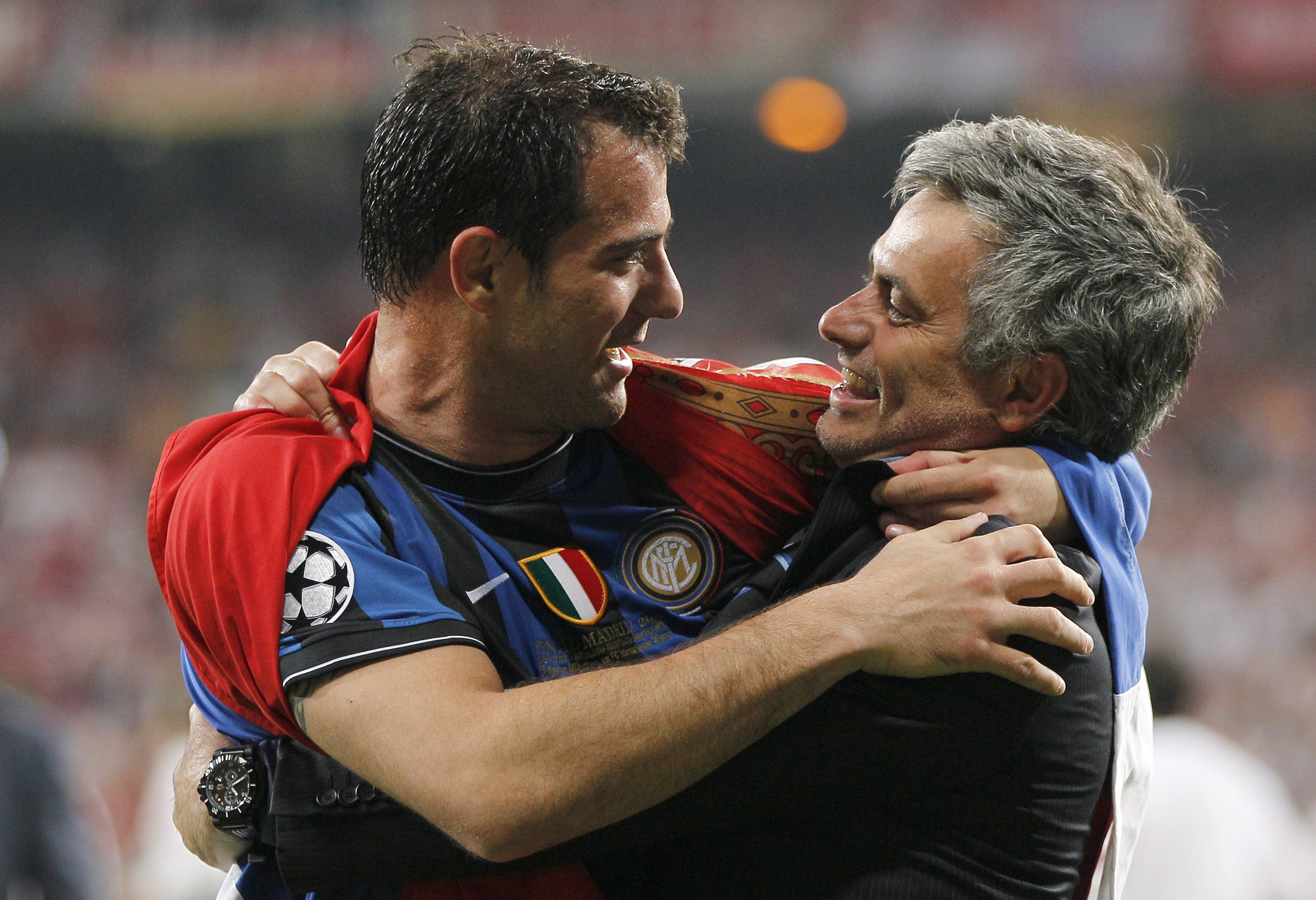 Inter Milan's manager Mourinho hugs Inter Milan's Stankovic after their Champions League final soccer match victory  against Bayern Munich in Madrid