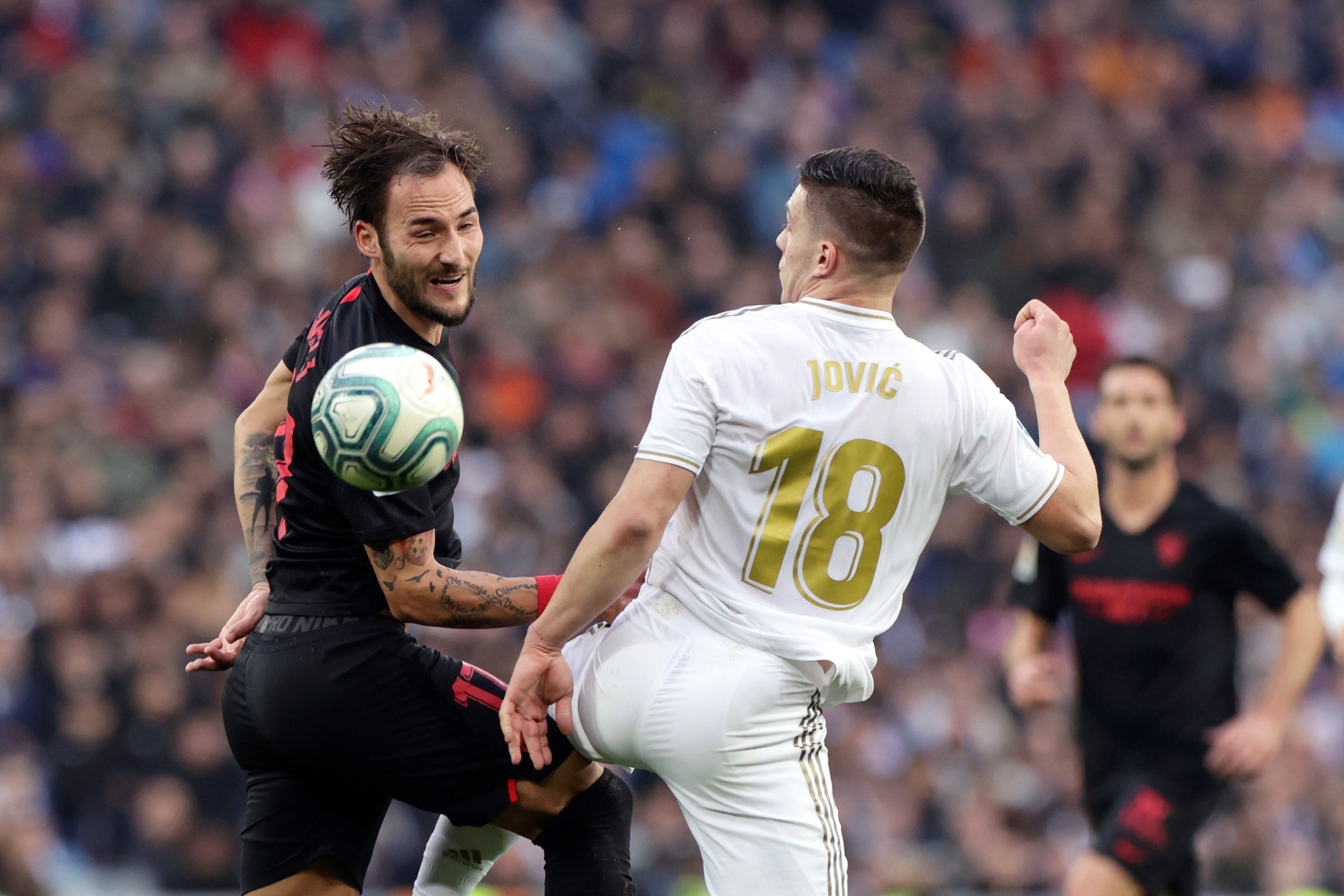 epa08138740 Real Madrid's Luka Jovic (R) in action against Sevilla FC's Nemanja Gudelj during a Spanish LaLiga soccer match between Real Madrid and Sevilla FC at the Santiago Bernabeu stadium in Madrid, Spain, 18 January 2020.  EPA-EFE/BALLESTEROS
