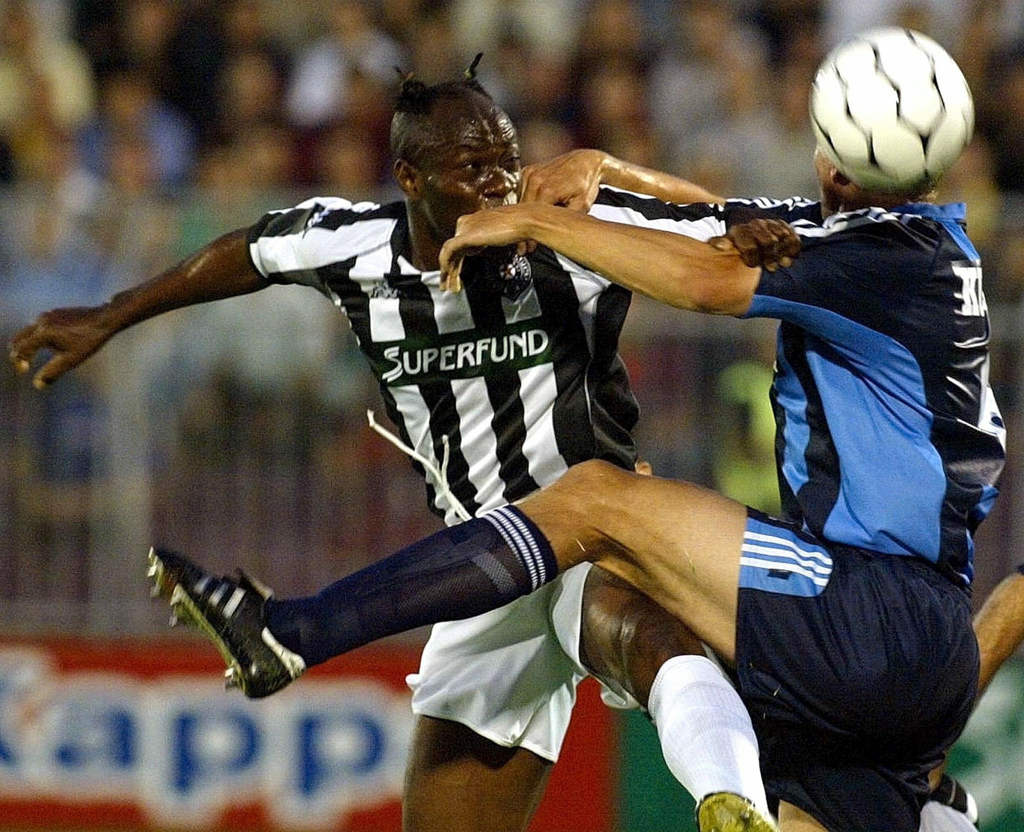 Nigerian player Taribo West (L) of Partizan Belgrade takes the header in front of an unidentified player of Swedish team Djurgardens during second qualifying round match for the UEFA Champions League match in Belgrade, on Wednesday July 30, 2003.