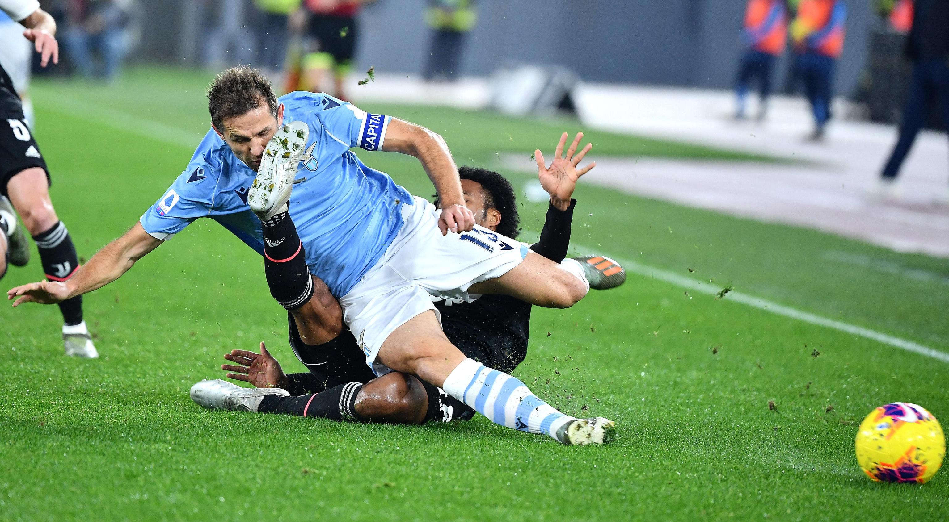 epa08053078 SS Lazio's Senad Lulic (R) vies for the ball with FC Juventus' Juan Guillermo Cuadrado during the Italian Serie A soccer match between SS Lazio and FC Juventus at the Olimpico stadium in Rome, Italy, 07 December 2019.  EPA-EFE/ETTORE FERRARI