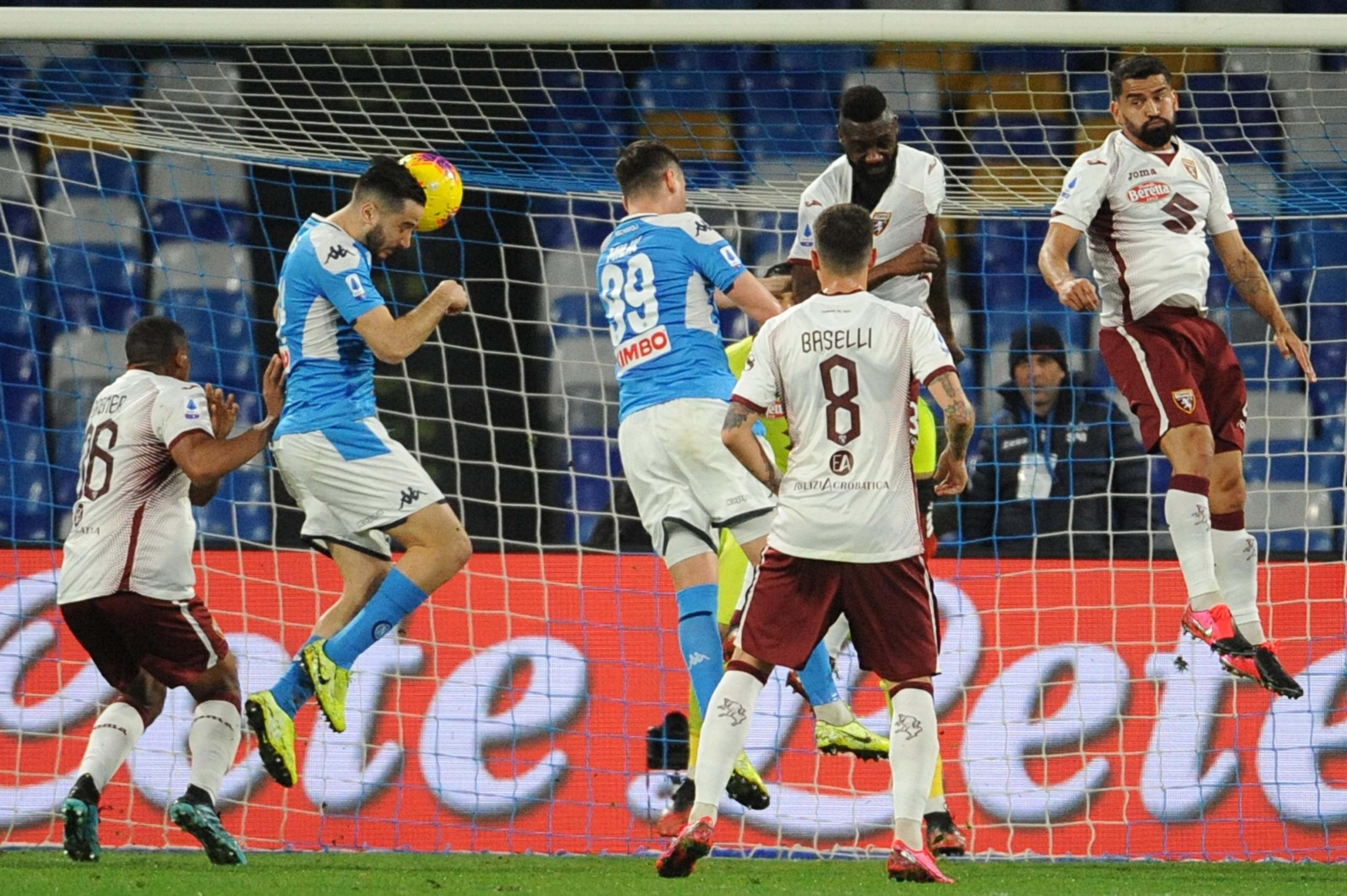 epa08260510 Napoli's Kostas Manolas (2L) goes for a header to score the opening goal during the Italian Serie A soccer match SSC Napoli vs Torino FC at the San Paolo stadium in Naples, Italy, 29 February 2020.  EPA-EFE/CESARE ABBATE