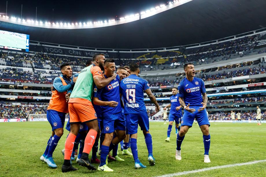 epa07900014 Cruz Azul's players celebrate upon scoring a goal during the Apertura Tournament (Liga MX) soccer match between Cruz Azul and Club America at the Azteca Stadium in Mexico City, Mexico, 05 October 2019.  EPA-EFE/JOSE MENDEZ