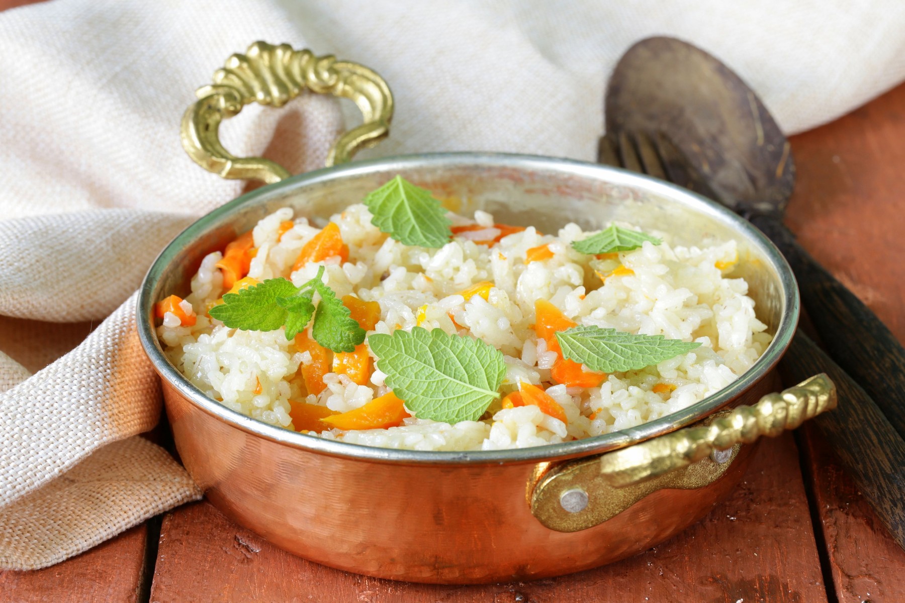 rice with vegetables cooked in Indian style in a copper pan