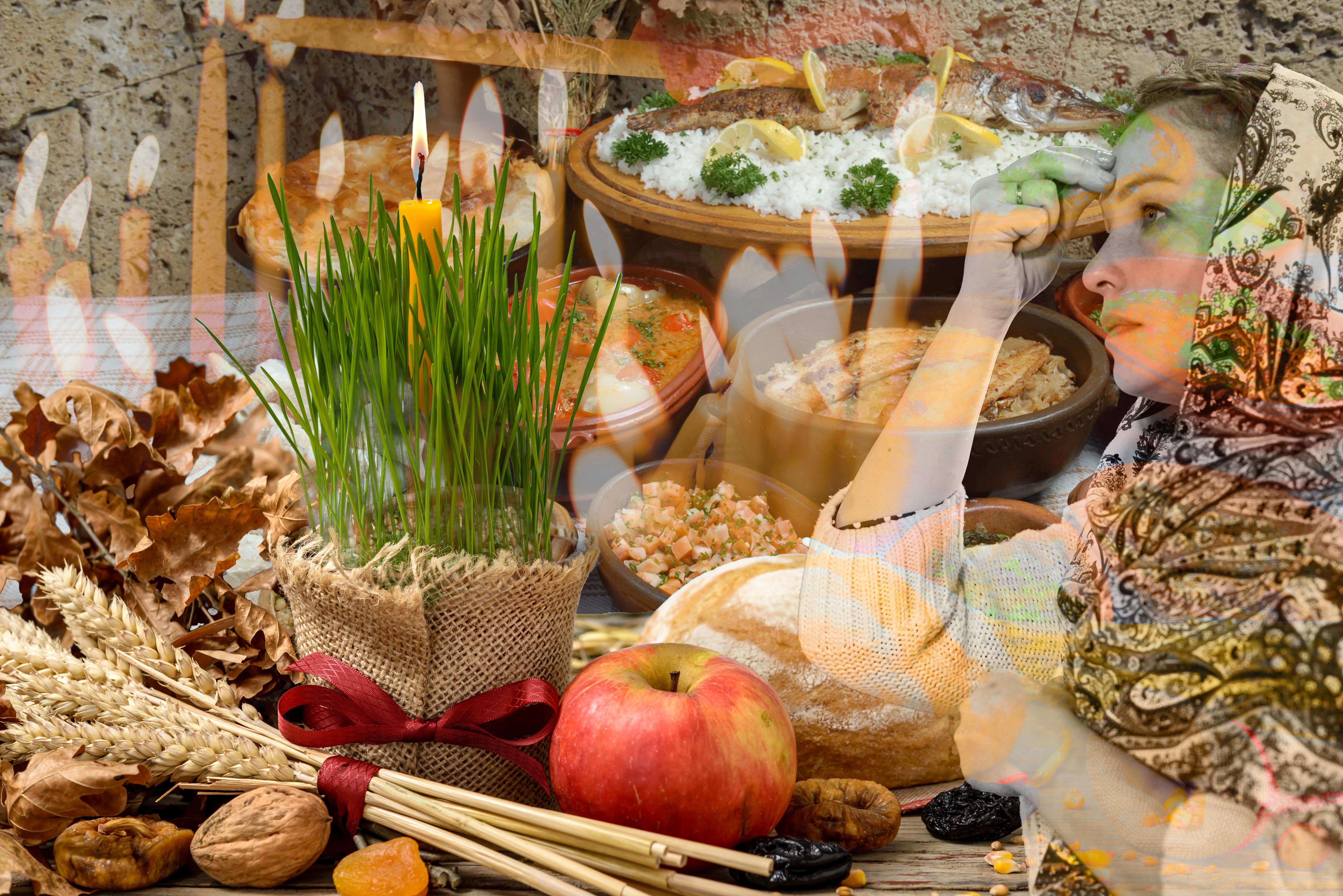 Traditional food for orthodox Christmas eve. Yule log or badnjak, apples, bread, cereals, dried fruit and a burning candle in green wheat on a wooden table. Concept celebration orthodox Christmas.