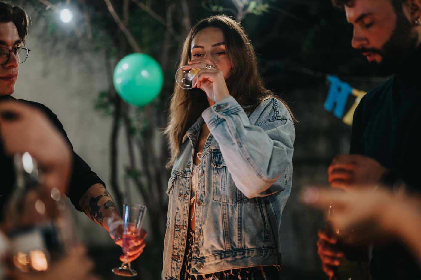 Group of friends celebrating a birthday at an outdoor evening party