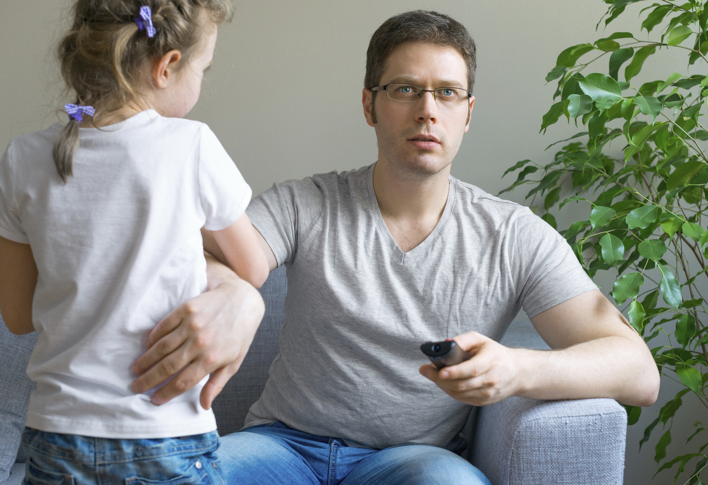 Little girl disturbing her dad while he is watching TV,Image: 1012881144, License: Royalty-free, Restrictions: , Model Release: yes, Credit line: DMITRI MARUTA / imageBROKER / Profimedia