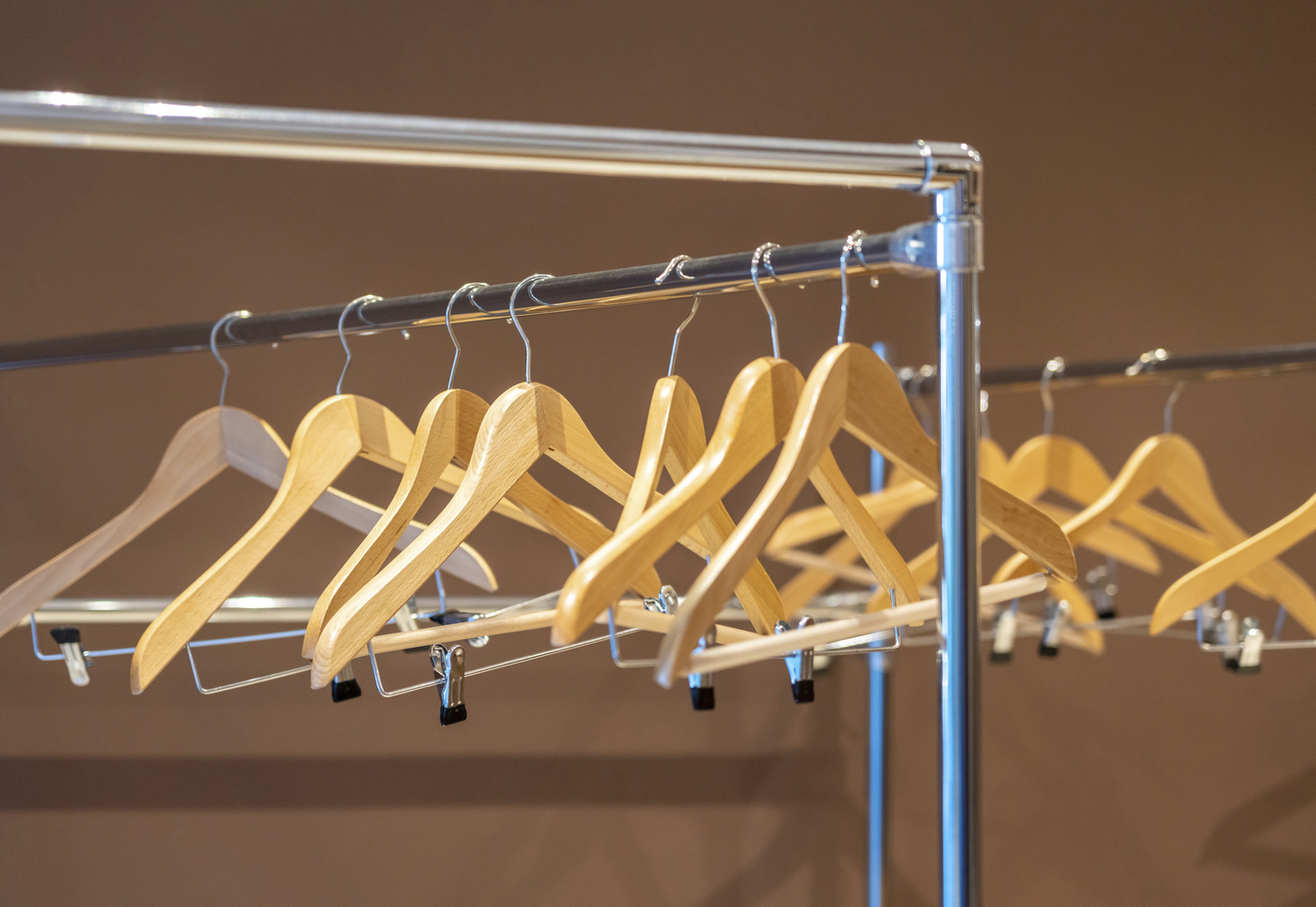 Wooden hangers on coat rack with no clothes in empty cloakroom,Image: 1050663866, License: Royalty-free, Restrictions: , Model Release: no, Credit line: Maria Kraynova / imageBROKER / Profimedia