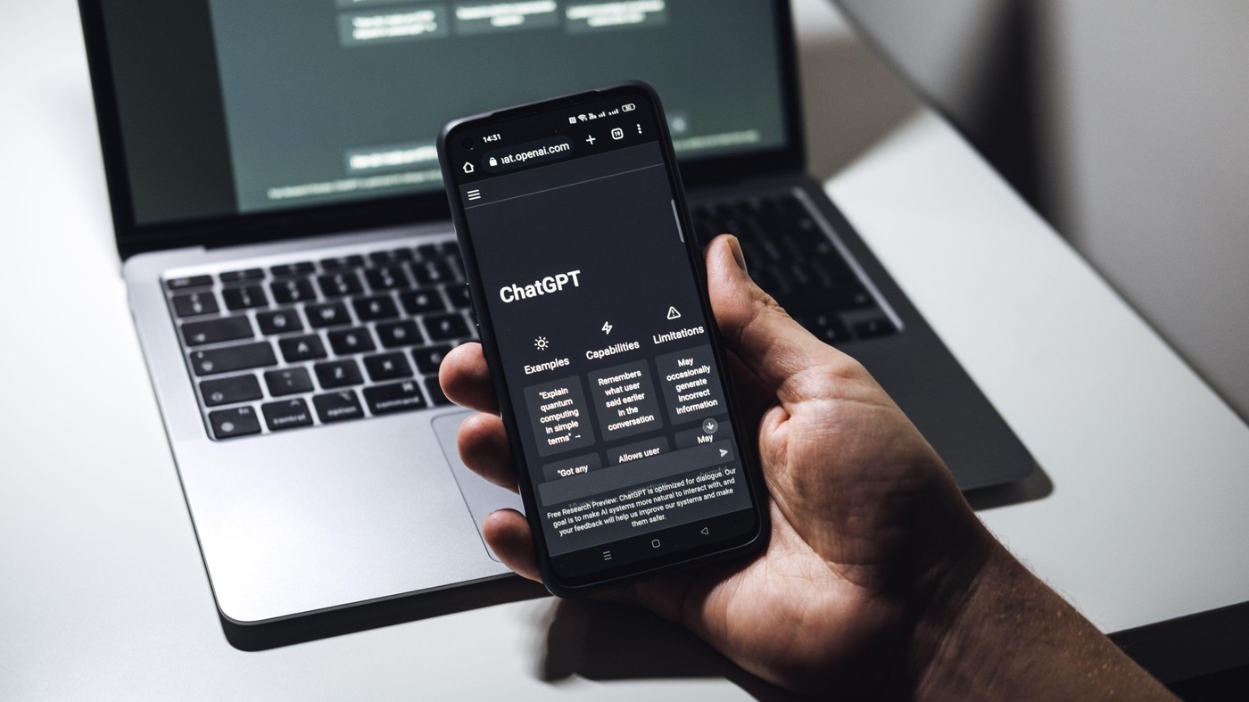 Screen with ChatGPT chat with AI or artificial intelligence. Man search for information using artificial intelligence chatbot developed by OpenAI