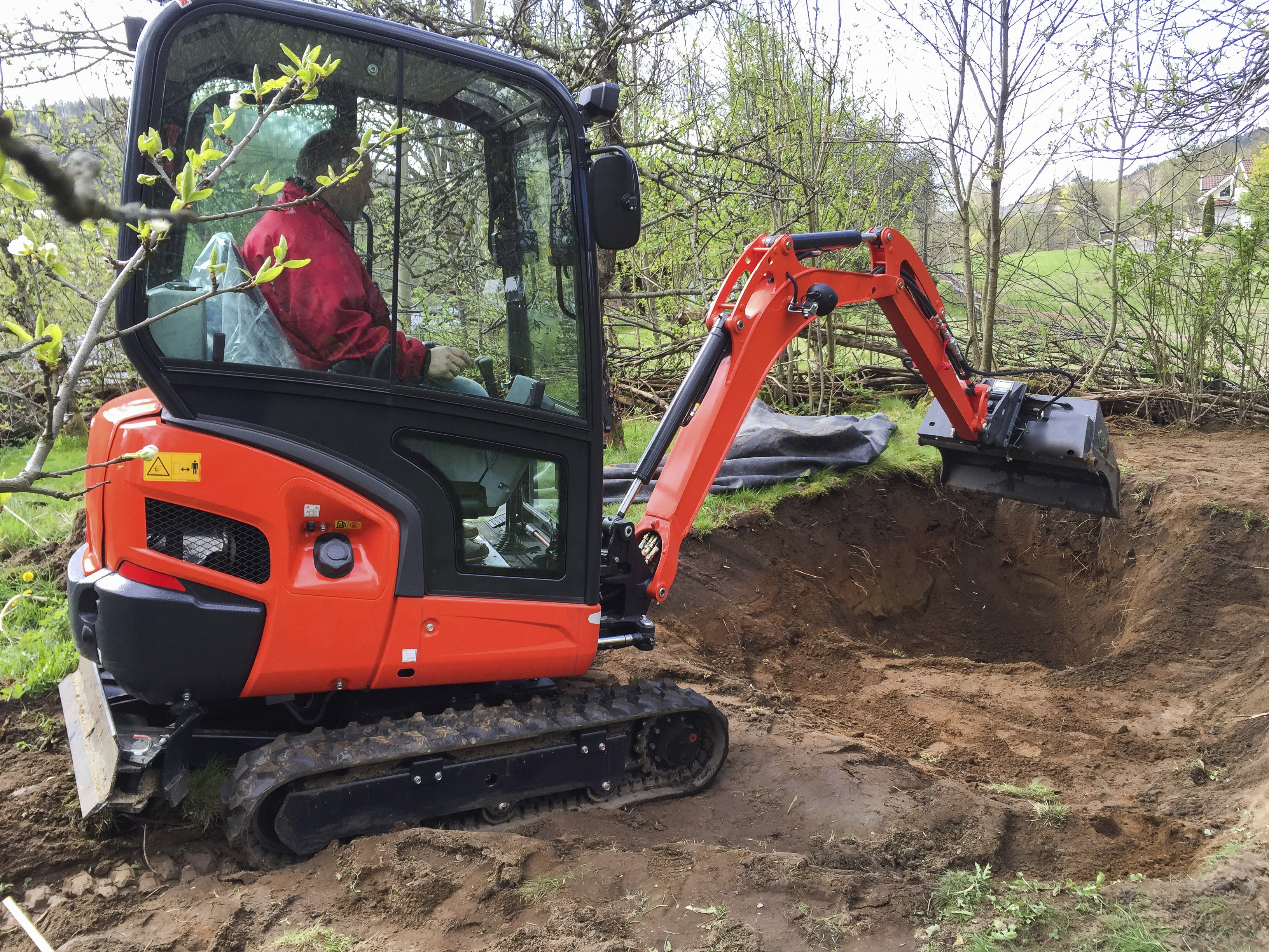 Picture of small excavator with man inside, at work making a garden pond,Image: 1050675251, License: Royalty-free, Restrictions: , Model Release: yes, Credit line: Lillian Tveit / imageBROKER / Profimedia