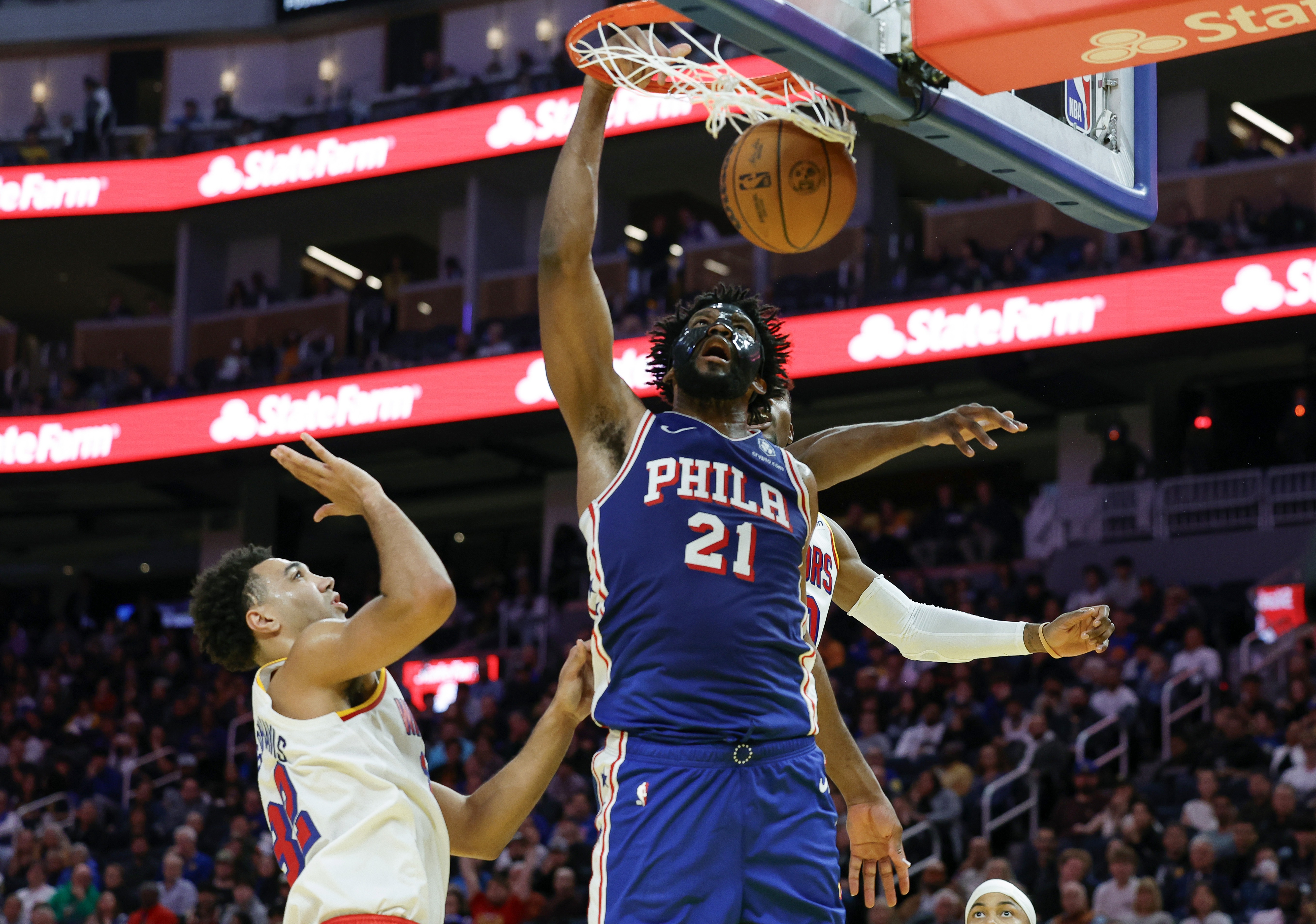 epa11803074 Philadelphia 76ers center Joel Embiid dunks past Golden State Warriors center Trayce Jackson-Davis during the second half of an NBA game in San Francisco, California, USA, 02 January 2025.  EPA/JOHN G. MABANGLO SHUTTERSTOCK OUT