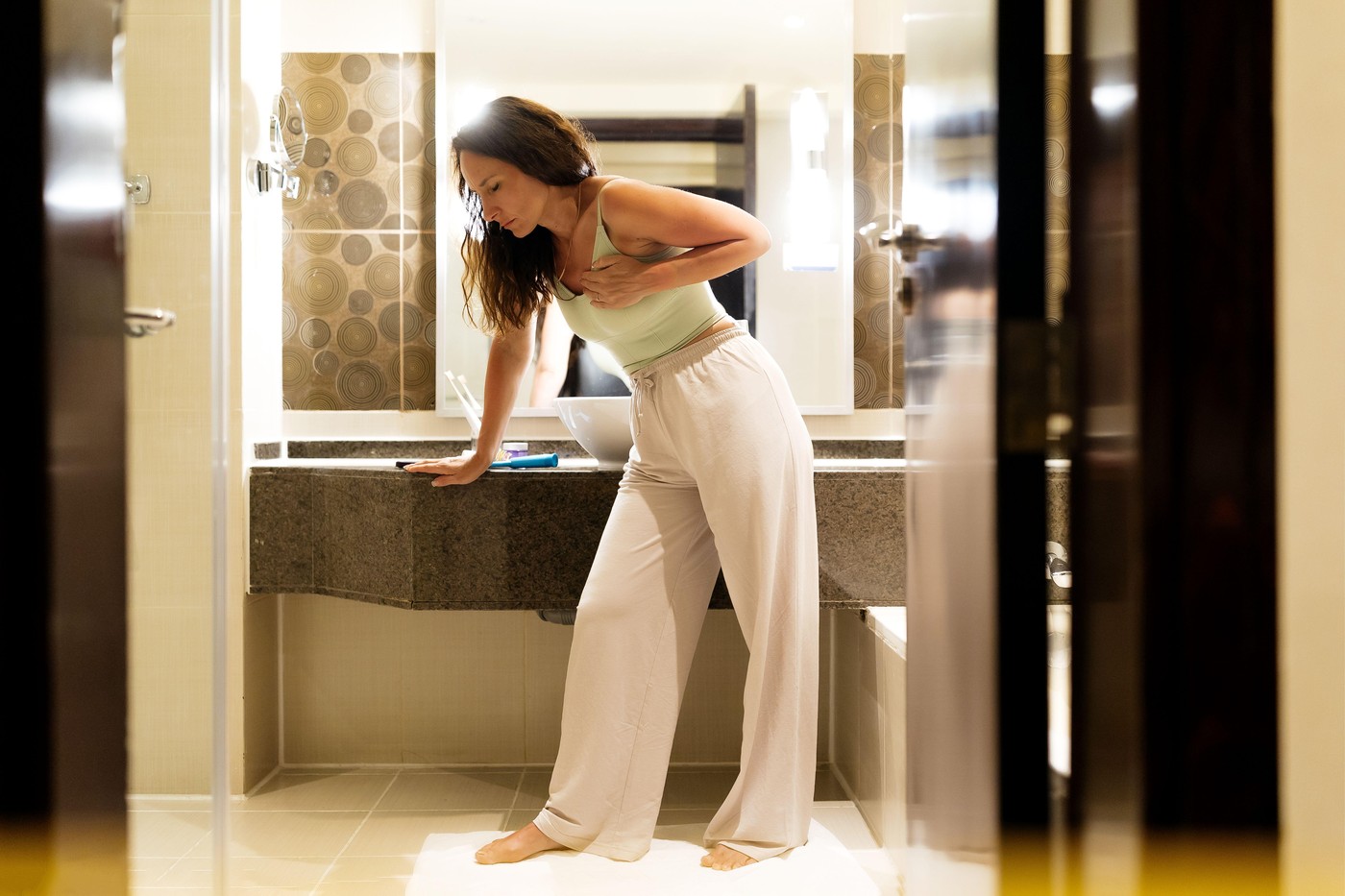 Heart Attack Concept. Woman seemingly feeling unwell and holding her chest