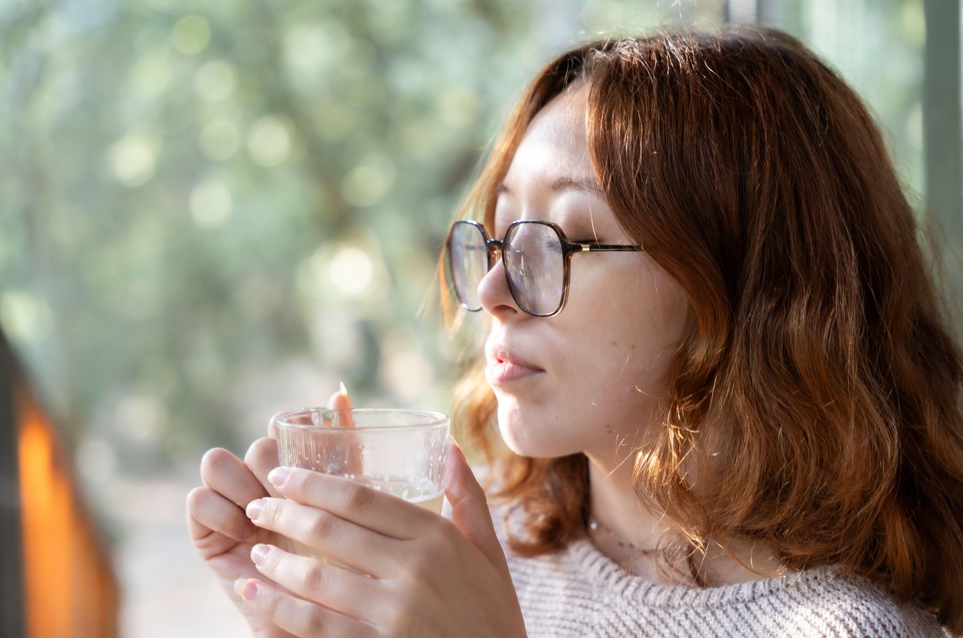 Young redhead woman enjoying a cup of tea in the terrace of a cabin,Image: 1048930177, License: Royalty-free, Restrictions: , Model Release: yes, Credit line: Laia Balart / Alamy / Profimedia