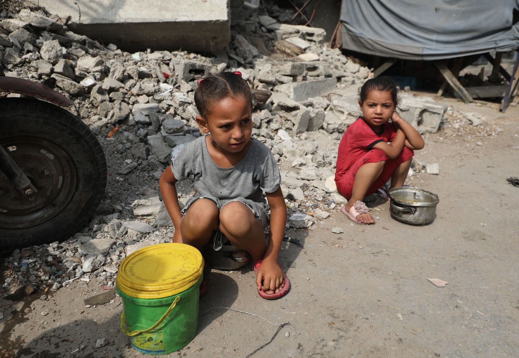 Palestinians wait to receive food from a charity kitchen, amid a hunger crisis, in Bureij, Bureij, Gaza Strip, Palestinian Territory - 12 Aug 2025
