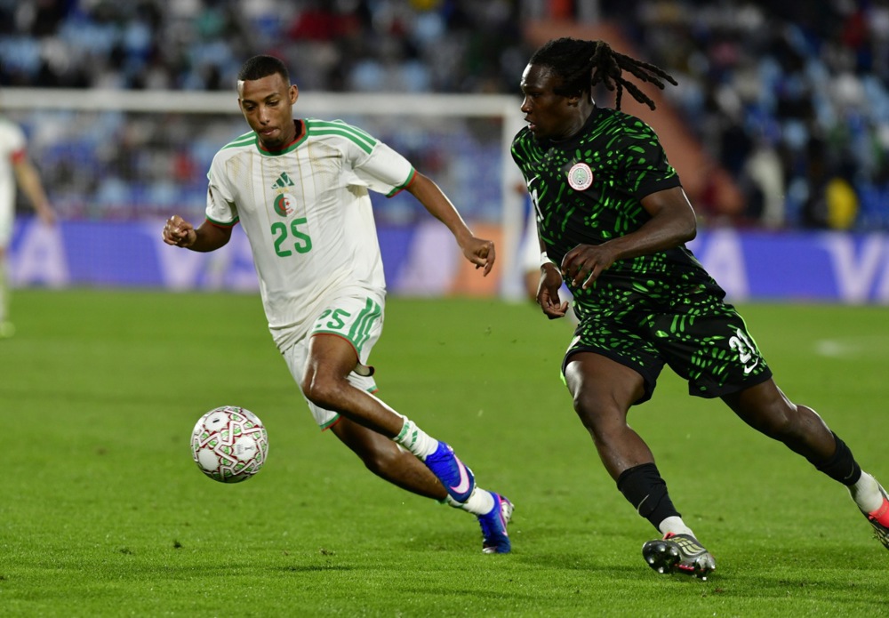 epa12641208 Nigeria's Calvin Chinedu Bassey (R) and Algeria's Rafik Belghali (L) in action during the CAF Africa Cup of Nations 2025, quarter final match between Algeria and Nigeria in Marrakesh, Morocco, 10 January 2026.  EPA/JALAL MORCHIDI