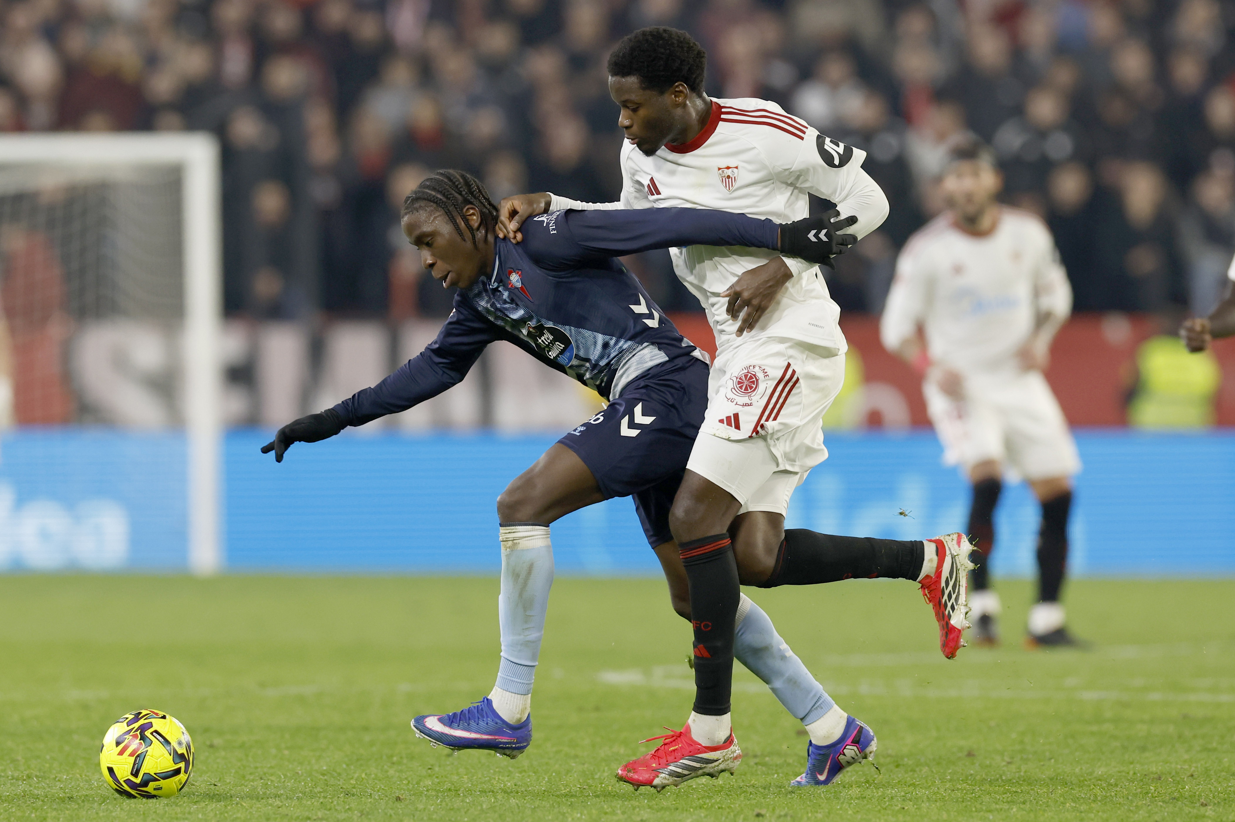 epa12645378 Sevilla´s French forward Lucien Agoume (R) in action against Ilaix Moriba (L) of Celta Vigoduring the Spanish LaLiga soccer match between Sevilla FC and RC Celta Vigo, in Seville, Spain, 12 January 2026.  EPA/Julio Munoz