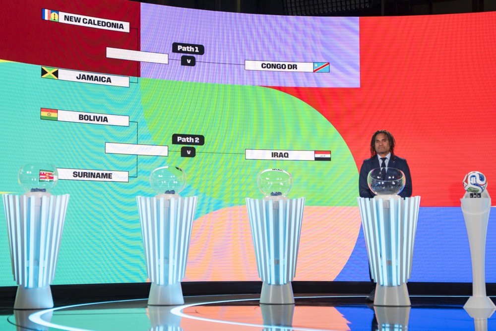 epa12537837 The playoff tree of the FIFA World Cup 2026 is shown on the screen next to Christian Karembeu  during the FIFA World Cup 2026 play-offs draw at the Home of FIFA in Zurich, Switzerland, 20 November 2025.  EPA/CLAUDIO THOMA