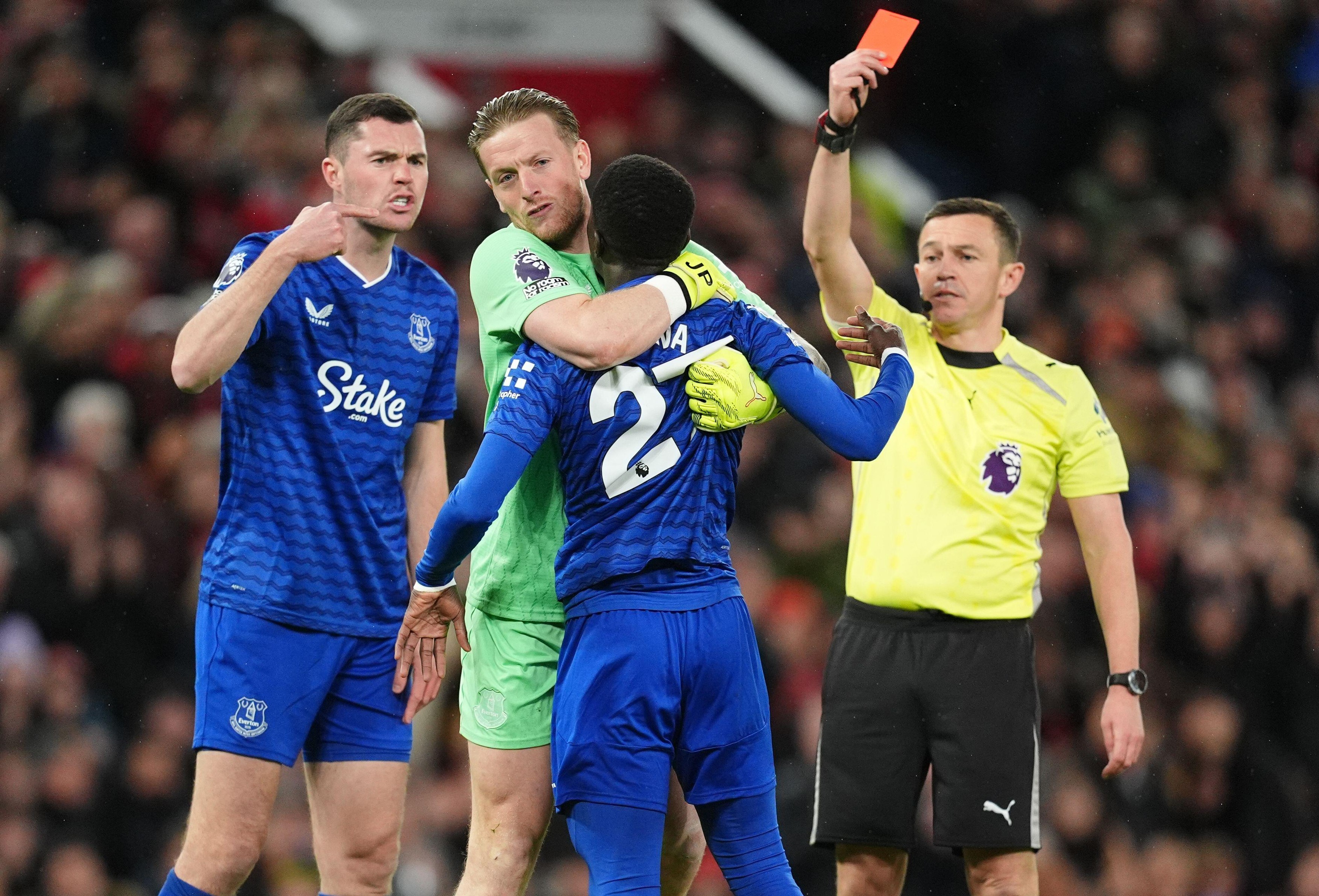 Everton's Idrissa Gueye is held back by Jordan Pickford after a confrontation with team mate Michael Keane, leading to a red card for Gueye during the Premier League match at Old Trafford, Manchester. Picture date: Monday November 24, 2025.